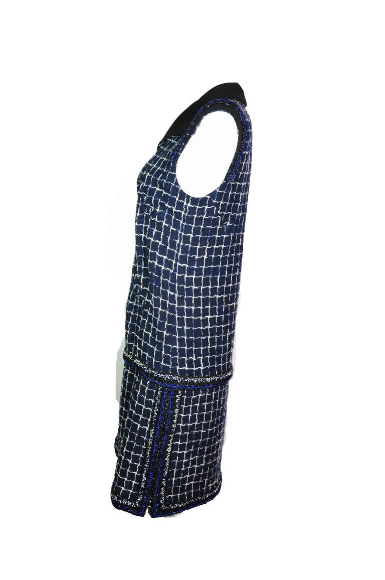 A classic and easy to wear Chanel summer cotton tweed dress in navy features with a black collar and padded shoulders. Concealed zip fastening to waist.   Four concealed zip fastening pockets in front. Concealed zip fastening at the lower sides.