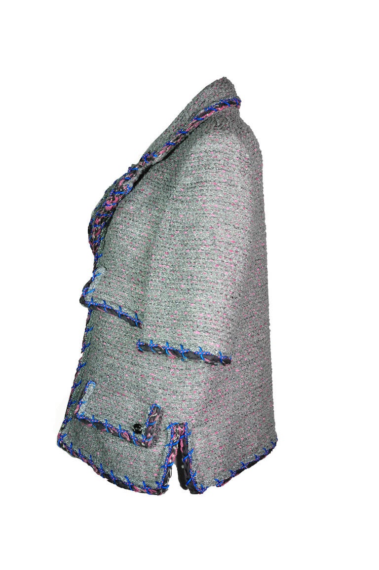 This fantasy tweed jacket is from Chanel 2014 spring/summer runway collection, the tweed is in the mix of silver, grey and pink colors with cobalt blue trims.  Four pockets at front with side slits. Concealed hook fastening through front.  Fully