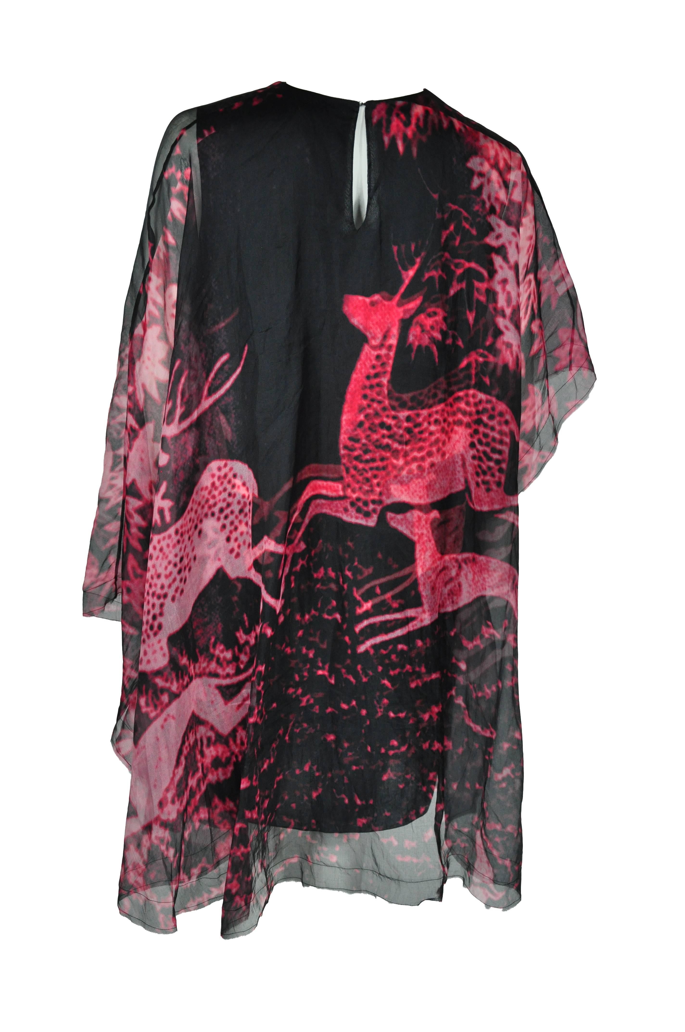 A round neck loose fit organza dress with red-deer prints from Lanvin 2015 collection. It features with asymmetric sleeves and a ruffled mini length hemline. Key hole button fastening at back.  Attached visible cotton slip dress.