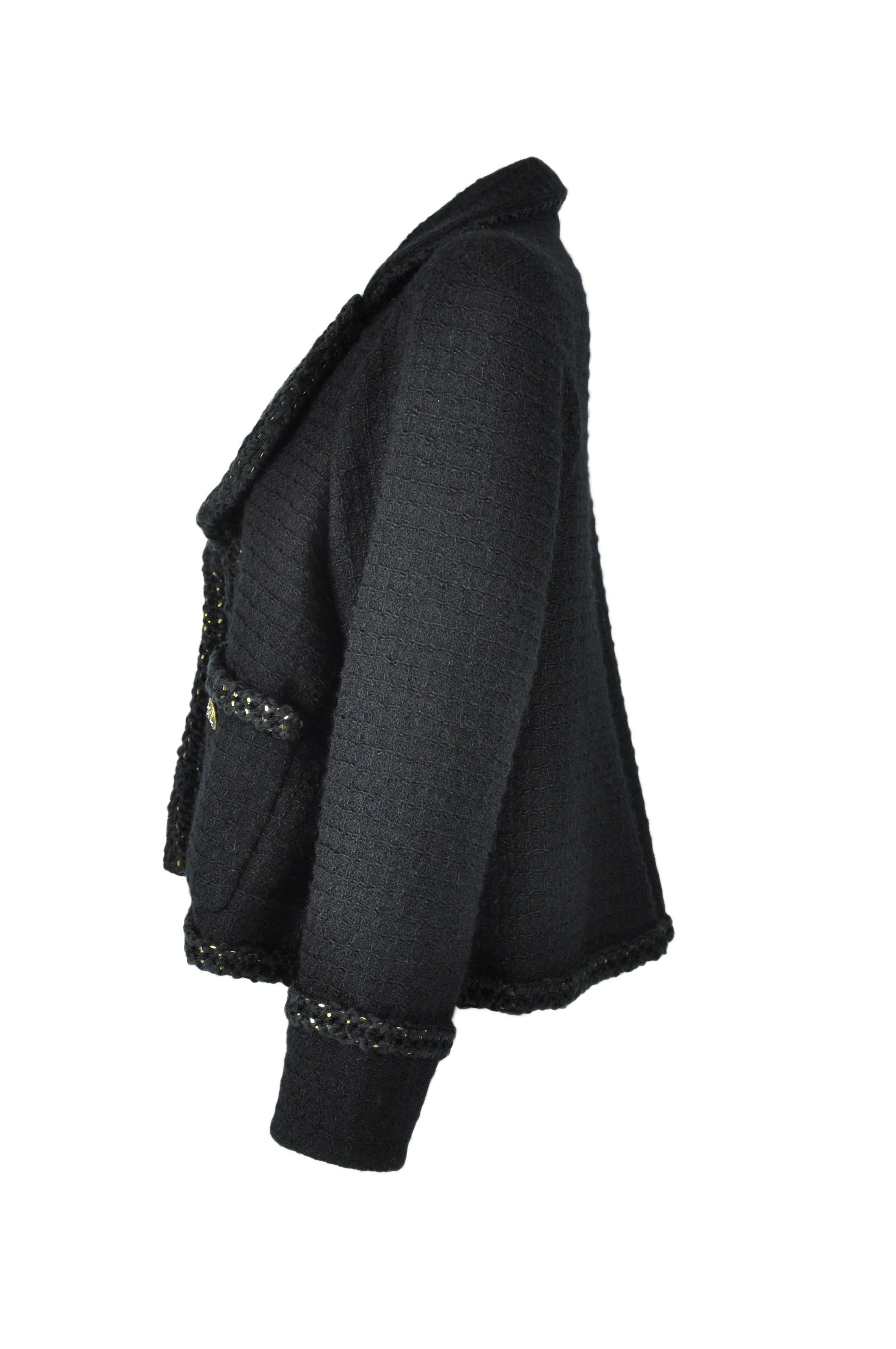 A sold out Chanel black wool tweed open jacket from 2015 Fall-winter collection.  It features with two open pockets at front and a high back vent.  Fully edged with gold ornate trimming.  Fully lined in silk.
