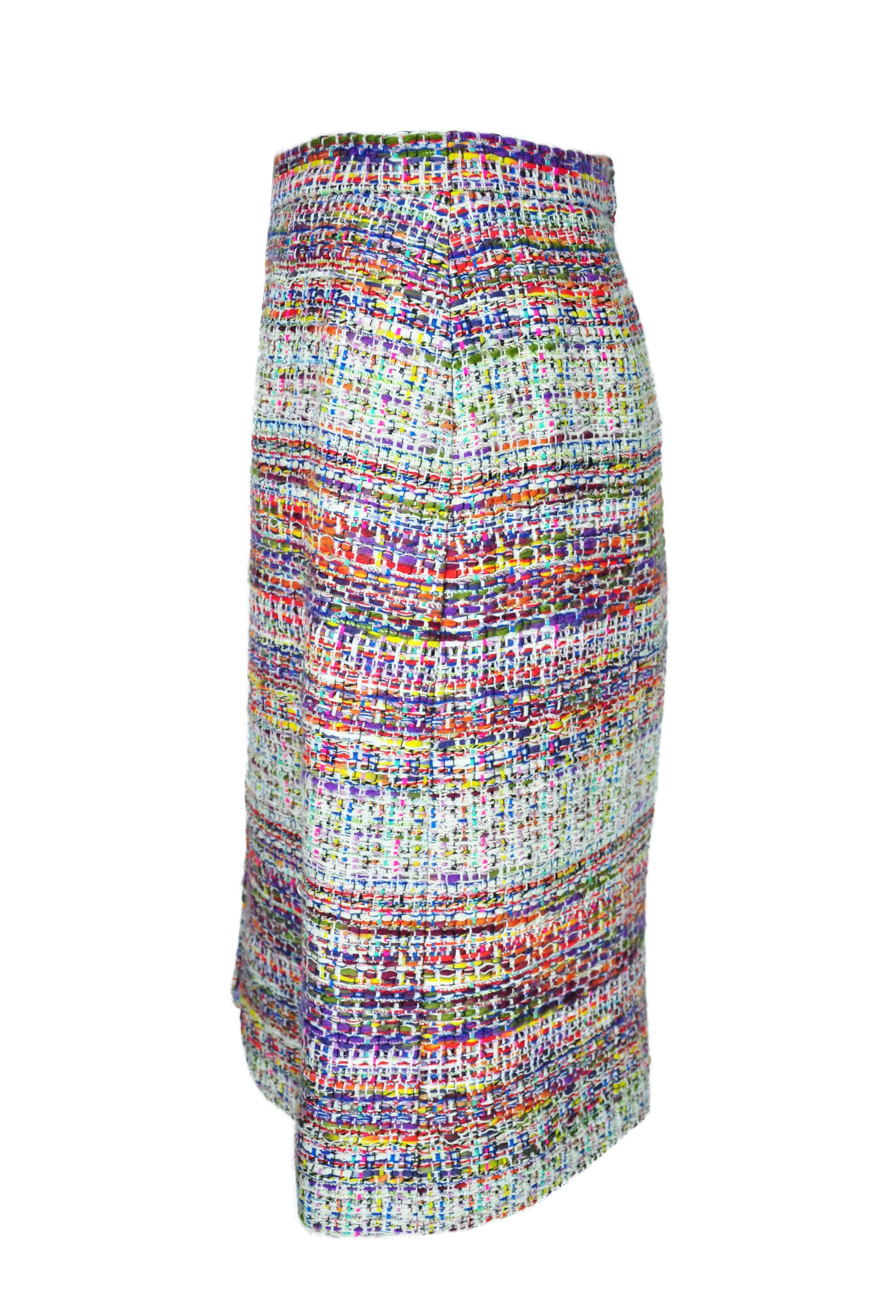 A multi-color fantasy tweed skirt from Chanel 2014 Fall/Winter collection. Banded waist with a zipper and a vent at front.  Concealed zip fastening at back.  Fully lined in multi-color silk.
