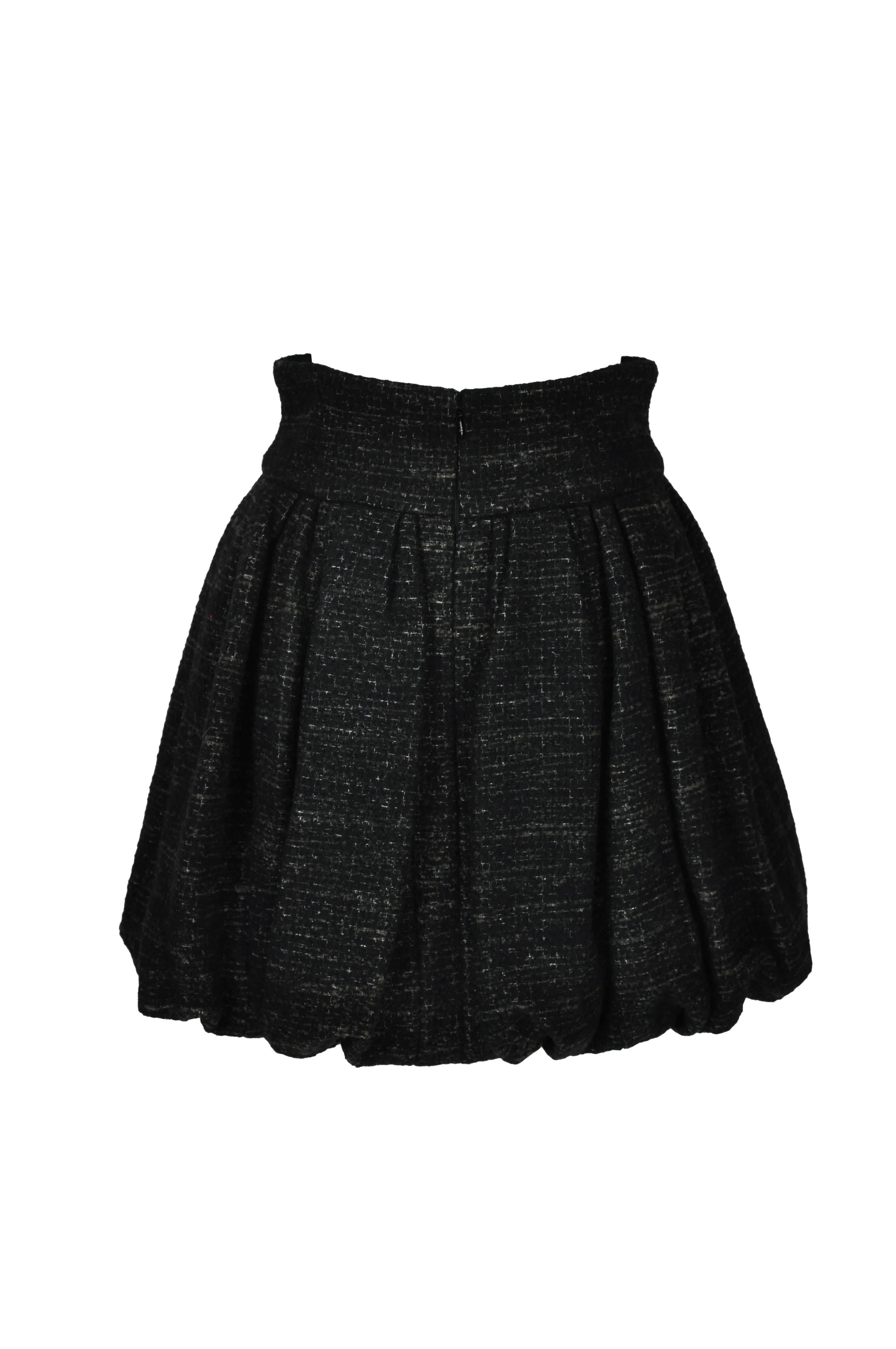 Chanel fully pleated and puffy wool tweed skirt from 2011 collection.  It features with banded waist and zip fastening at back.  Fully lined in silk.