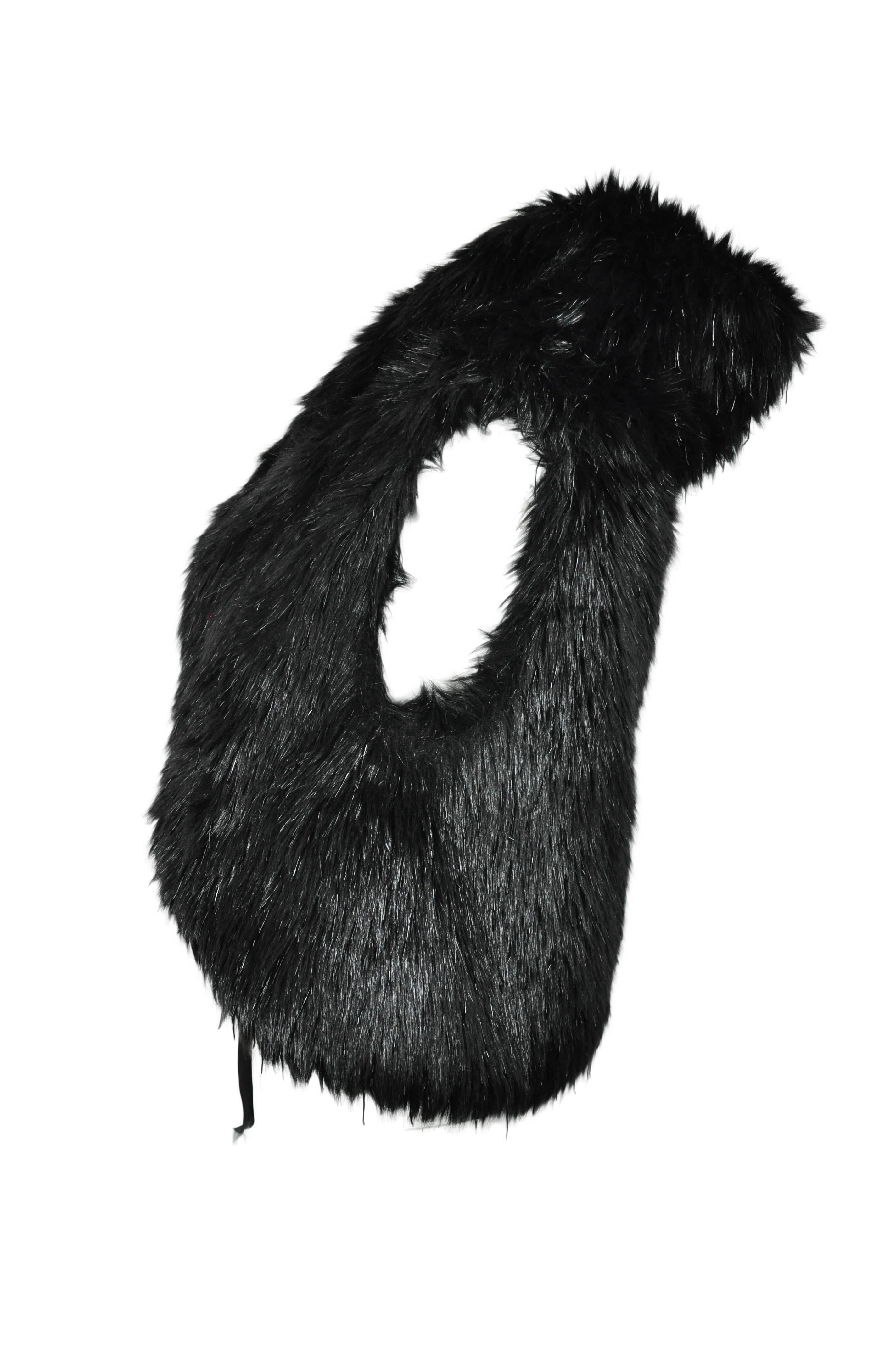 Chanel black faux fur vest from 2010 collection. It features with embellished bead threads on the fun fur. Ribbons tie at waist closure. Fully lined in silk.