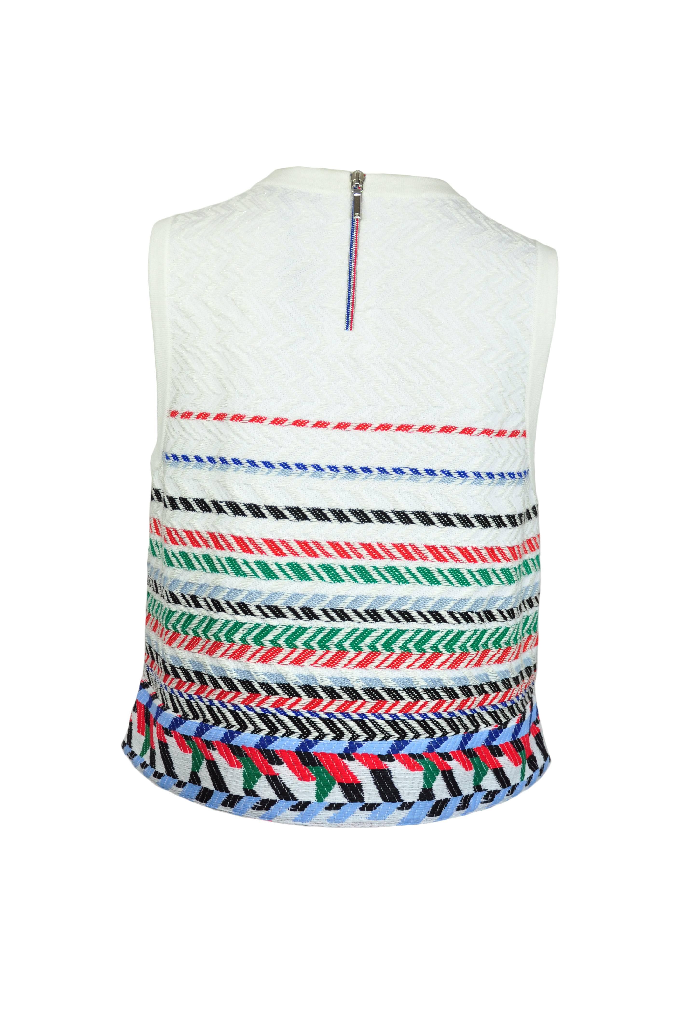 This round neckline sleeveless A shape top in white with multi-color details is from Chanel 2016 Airline collection.   Slit sides with zip fastening at back.