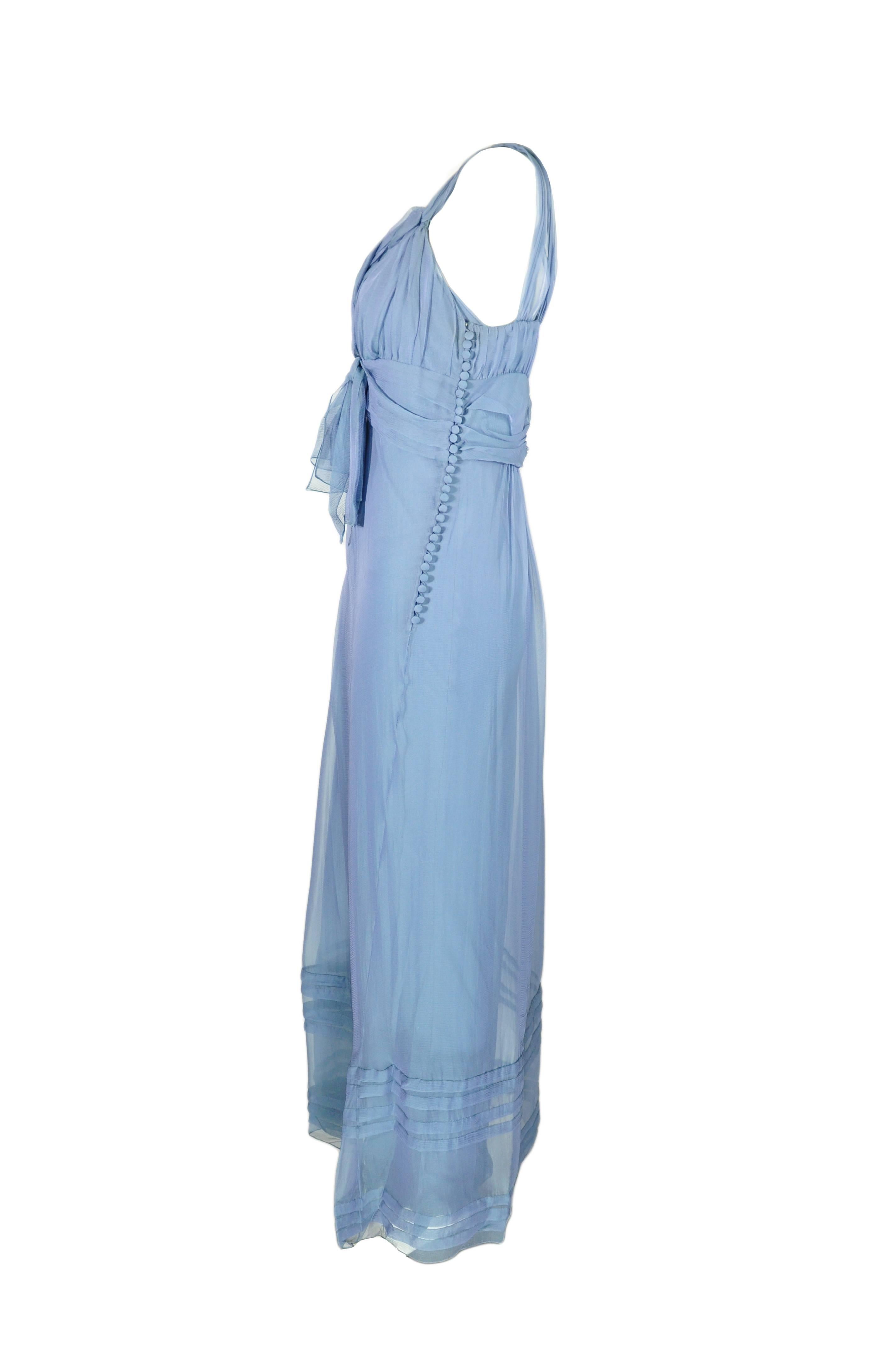 A beautiful silk chiffon ruffled hem maxi dress in ciel bleu from Dior by John Galliano featuring  the pleated bodice with ties and shoulder straps. Button and loop fastening at side with a slip dress. 