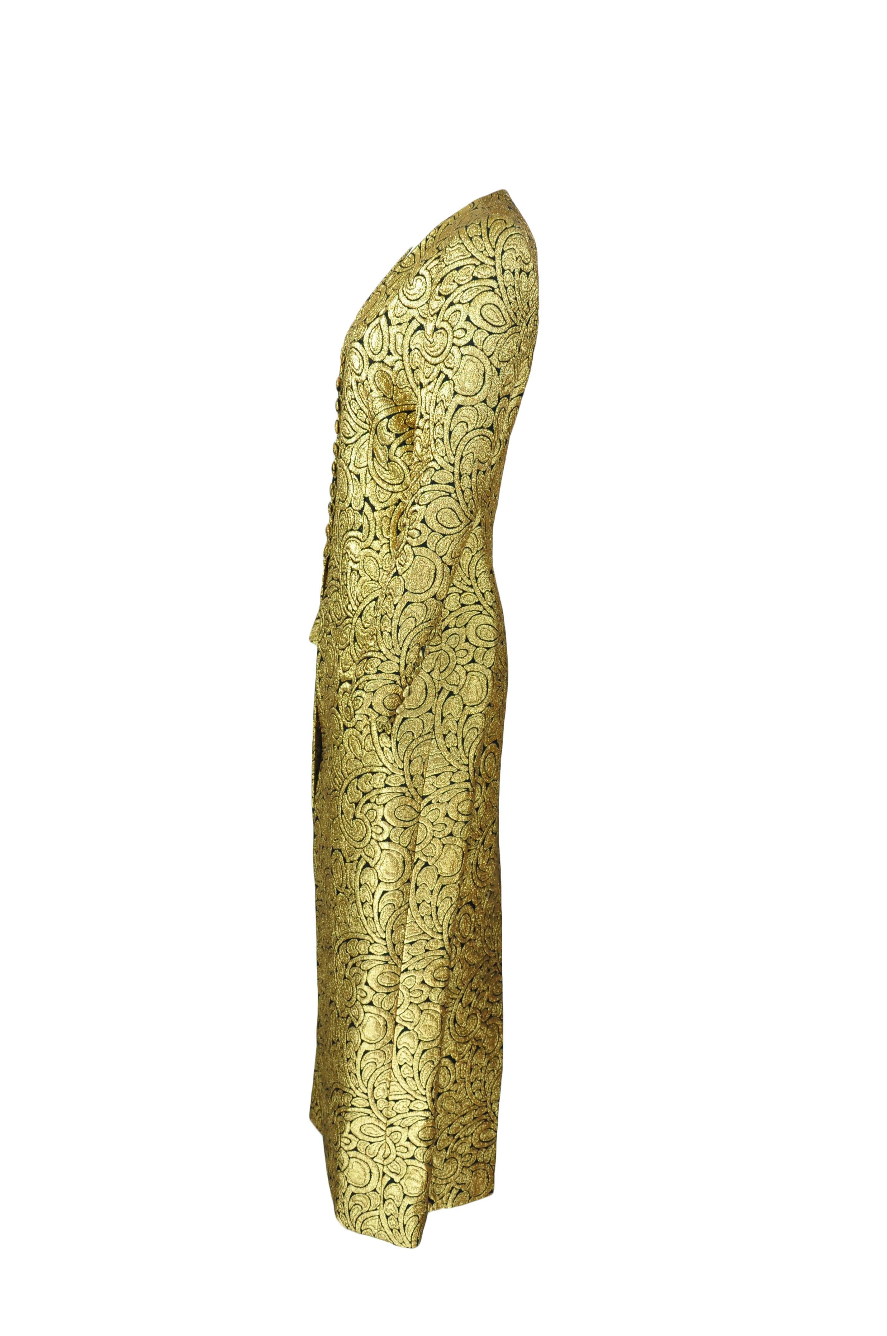An exceptional V-neck long sleeves gold brocade maxi dress from Celine by Michael Kors. Button and loop fastening at front with a high slit at back. Fully lined. 