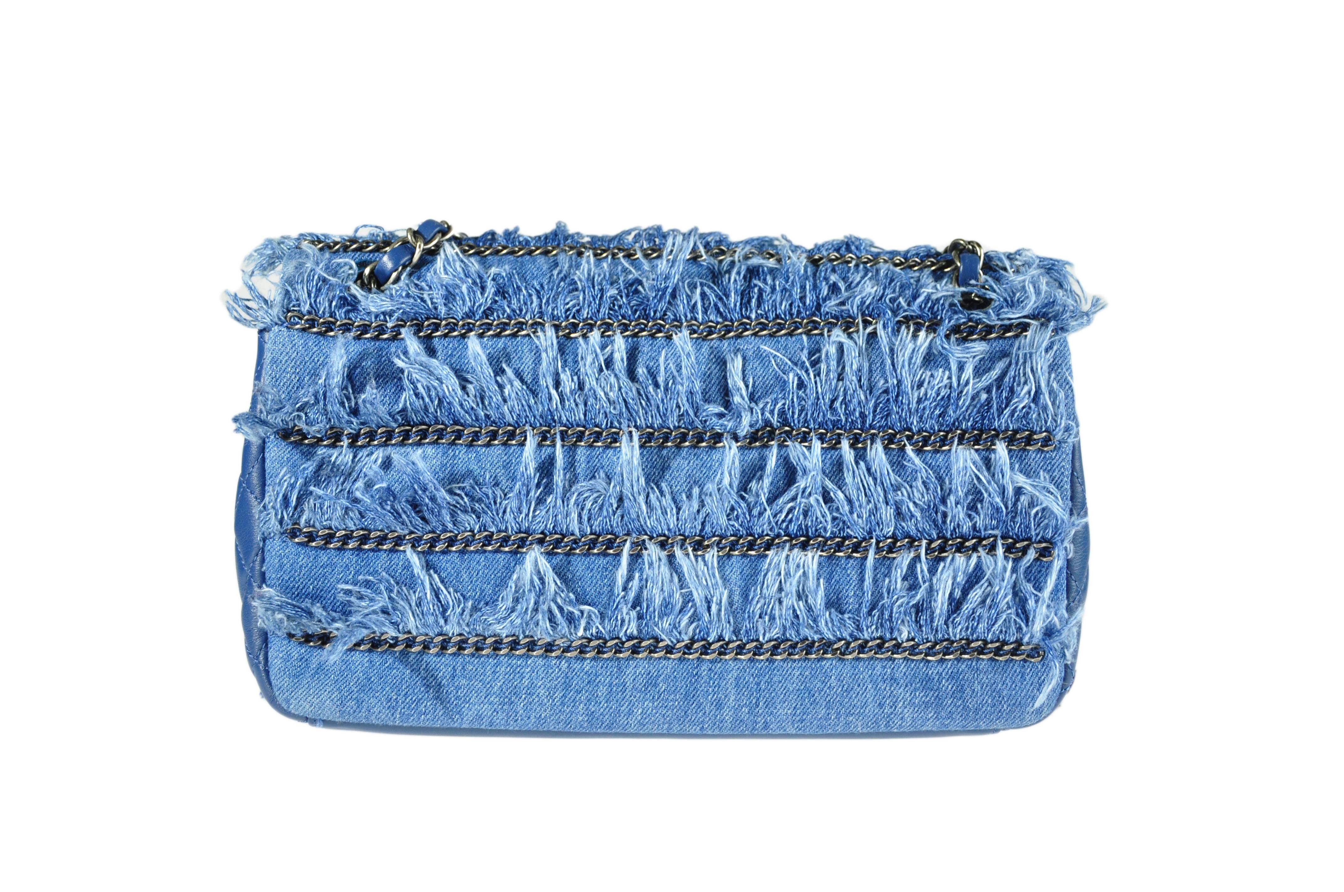 This fringe denim flag bag is from Chanel Dubai Cruise collection. It's beautifully crafted with fringe and chains. The chain shoulder strap is decorated with a few medallions and can be worn across the body.  CC turn lock closure on flap, one