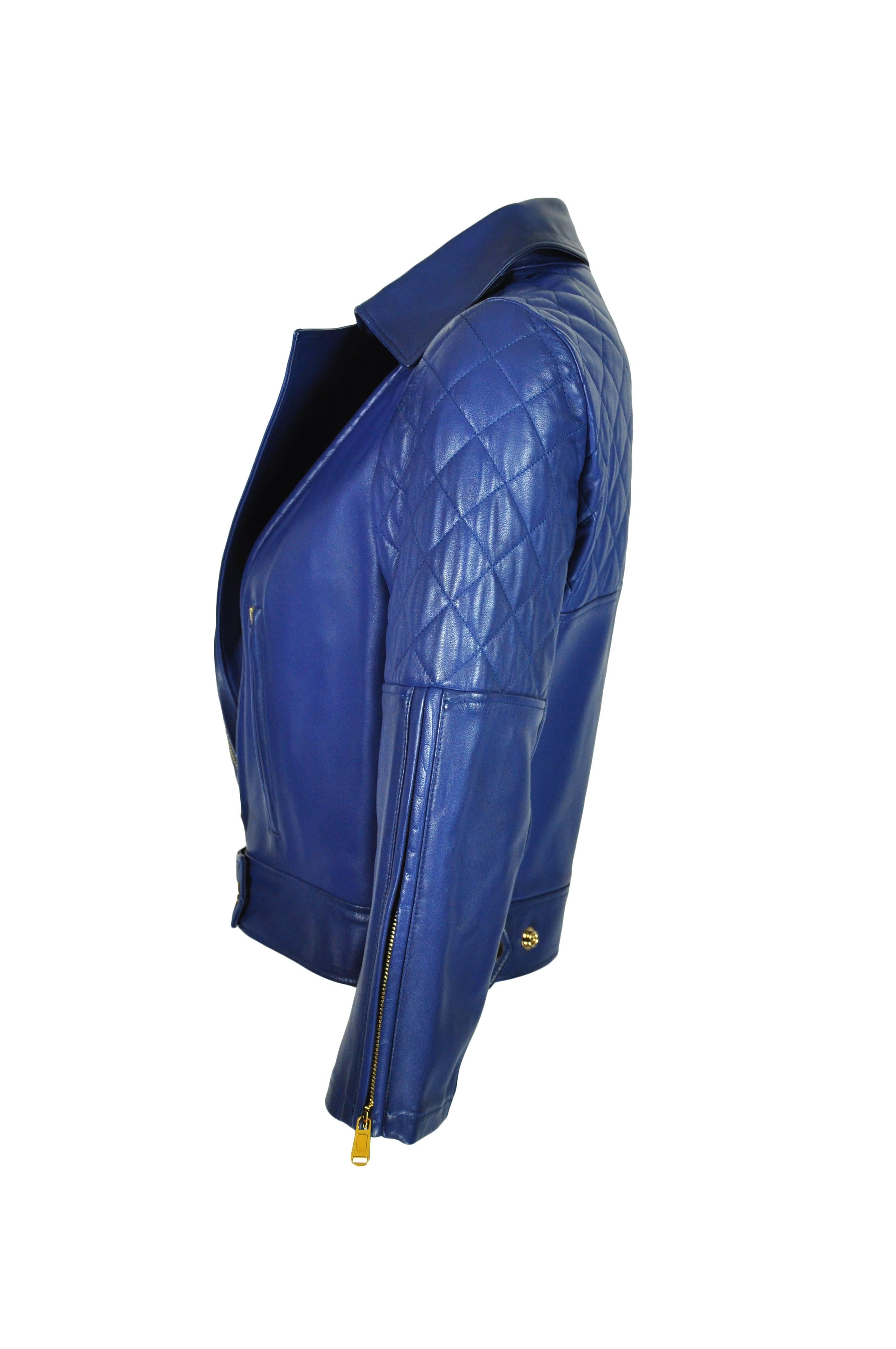 A sold out YSL blue leather biker jacket, quilted shoulders and back with three zip-fastening front pocket and one large snap fastening front pocket.  Snap fastening at hem with zip fastening cuffs. Partly lined.  