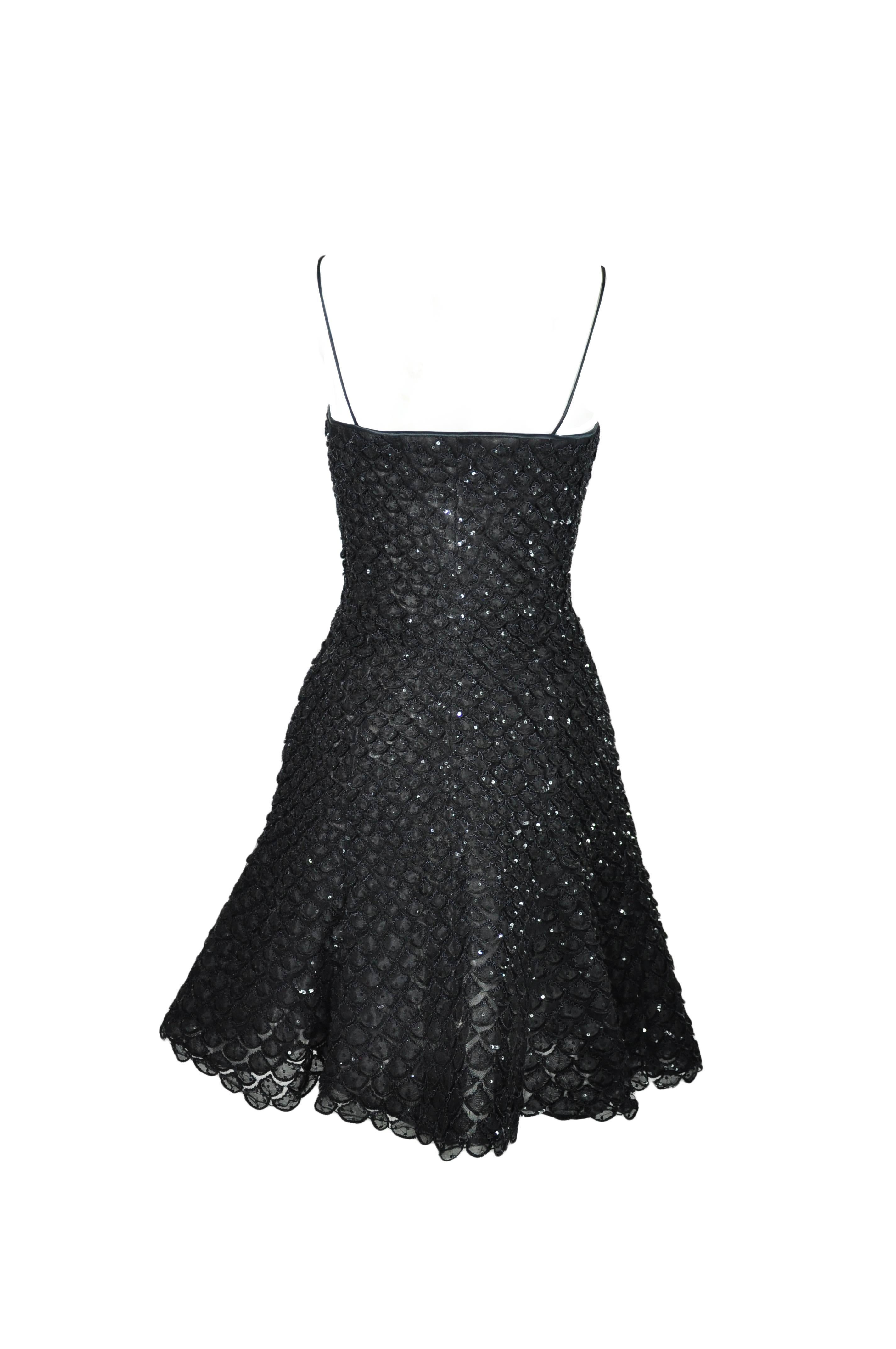 This timeless and feminine sequin appliques mini black dress has been impeccable crafted with slim straps. The under boned tulle has made the dress looks very voluminous. Zip fastening at side.
