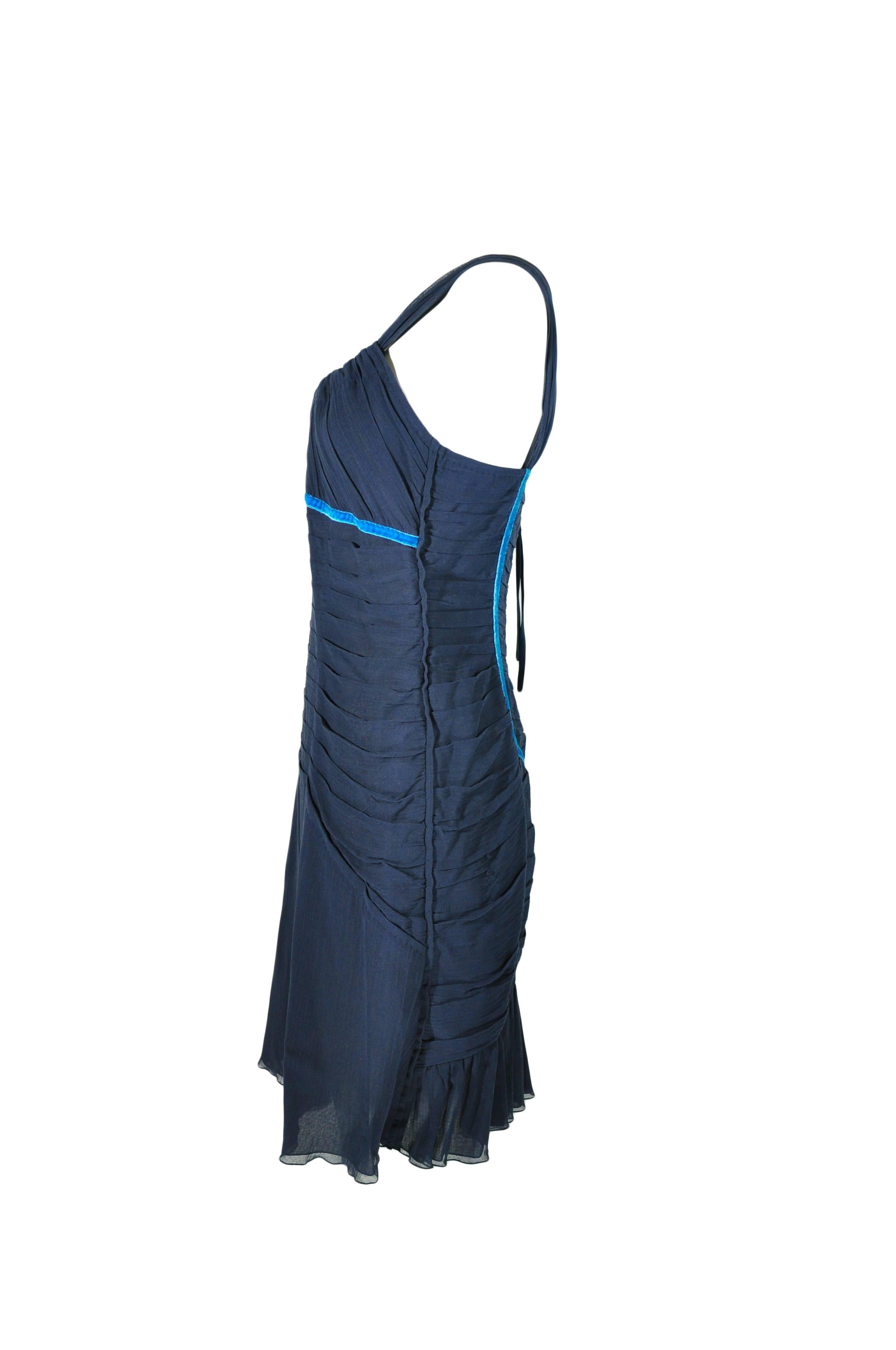 A strapped navy ruched mini cotton dress trimmed with turquoise velvet from Louis Vuitton.  Ruffled hem with zip fastening at back. Fully lined.