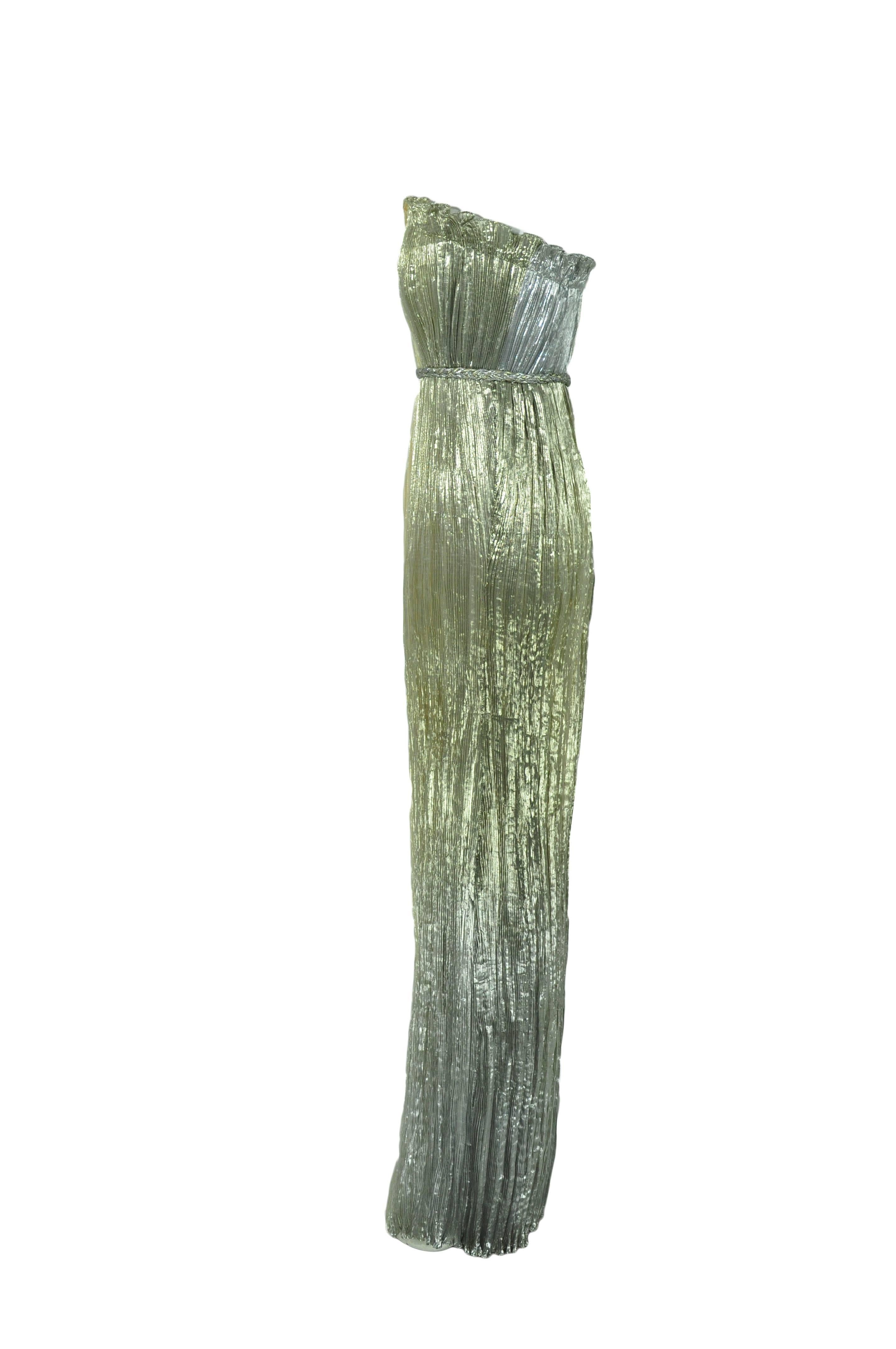 An ancient Greek inspired goddess gown from late designer Oscar de la Renta 2012 S/S collection.  Ruched and boned bodice with a gold and silver braid. Zip fastening at back. Fully lined in silk.