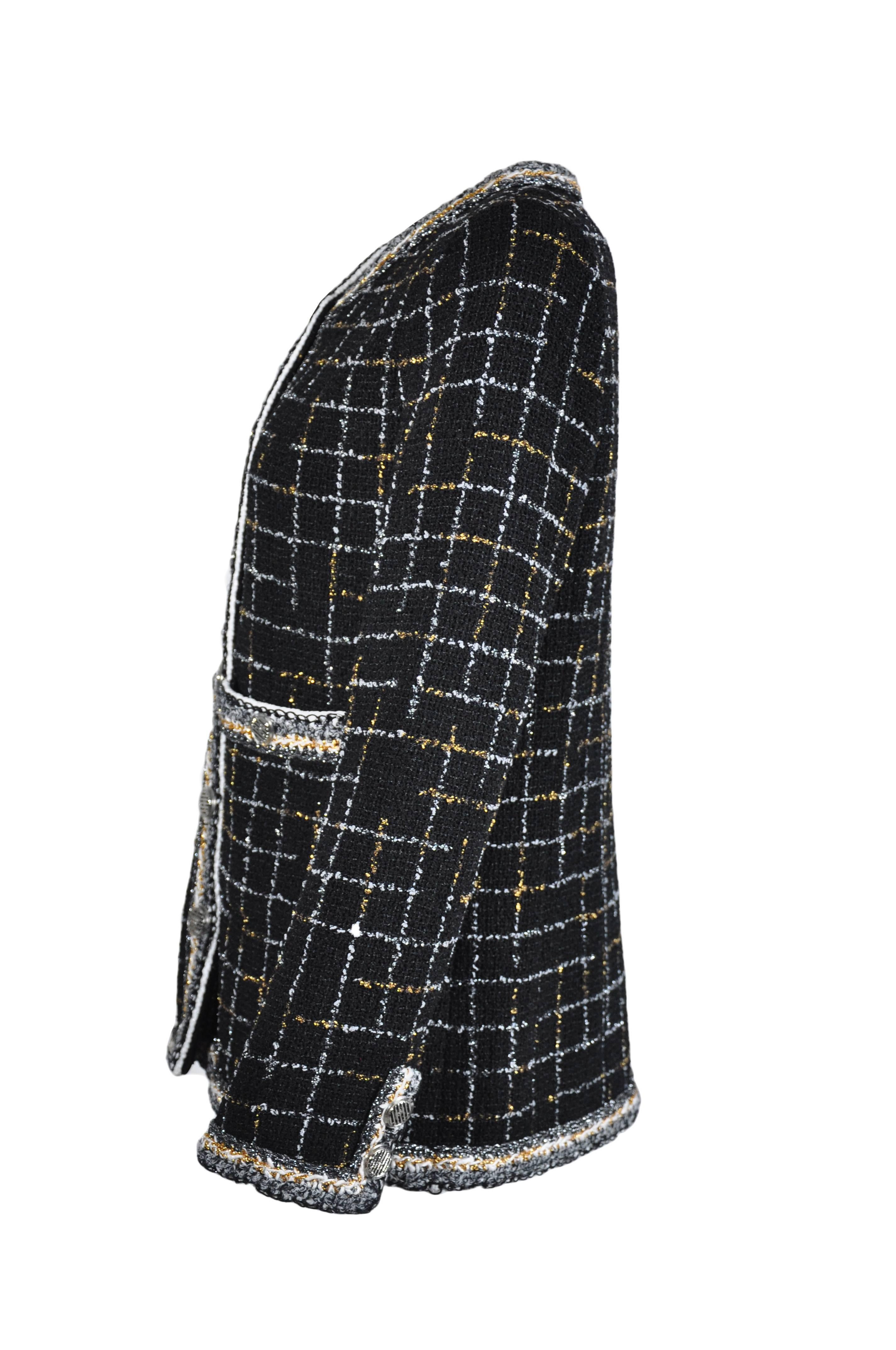 A sold out iconic tweed jacket from Chanel 2017 Spring/Summer runway collection.  Classic black tweed jacket decorates with gold/silver tone grids and trimmings. Button fastenings through front with two pockets. Fully lined in silk.