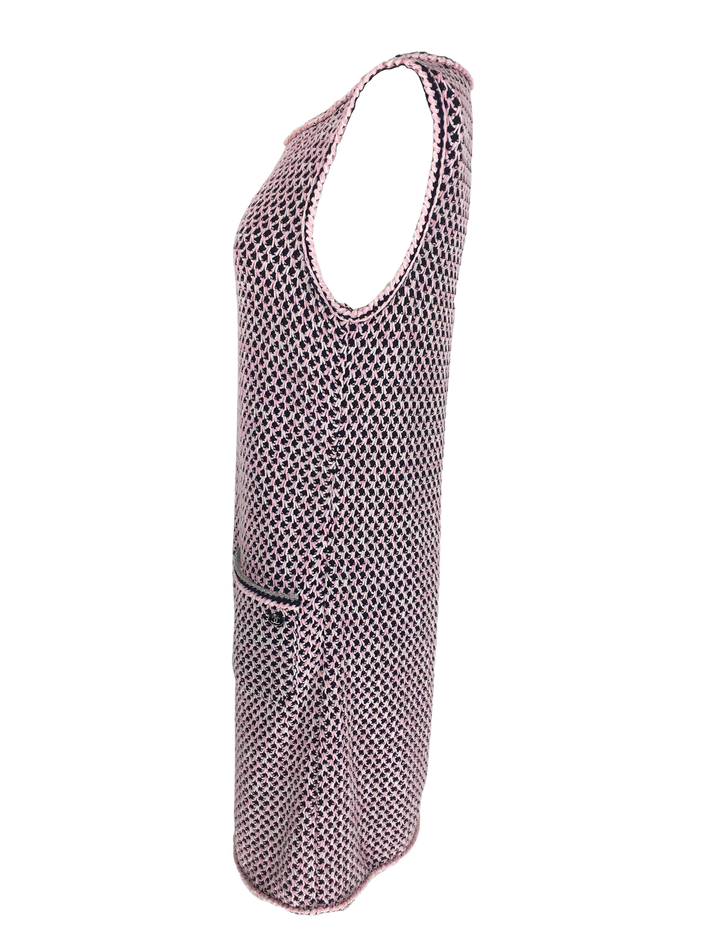 A  slip on sleeveless Cotton and Silk knit dress in pink/black/grey colors. Scoop neck, mid length and two front pockets and one cc logo button.