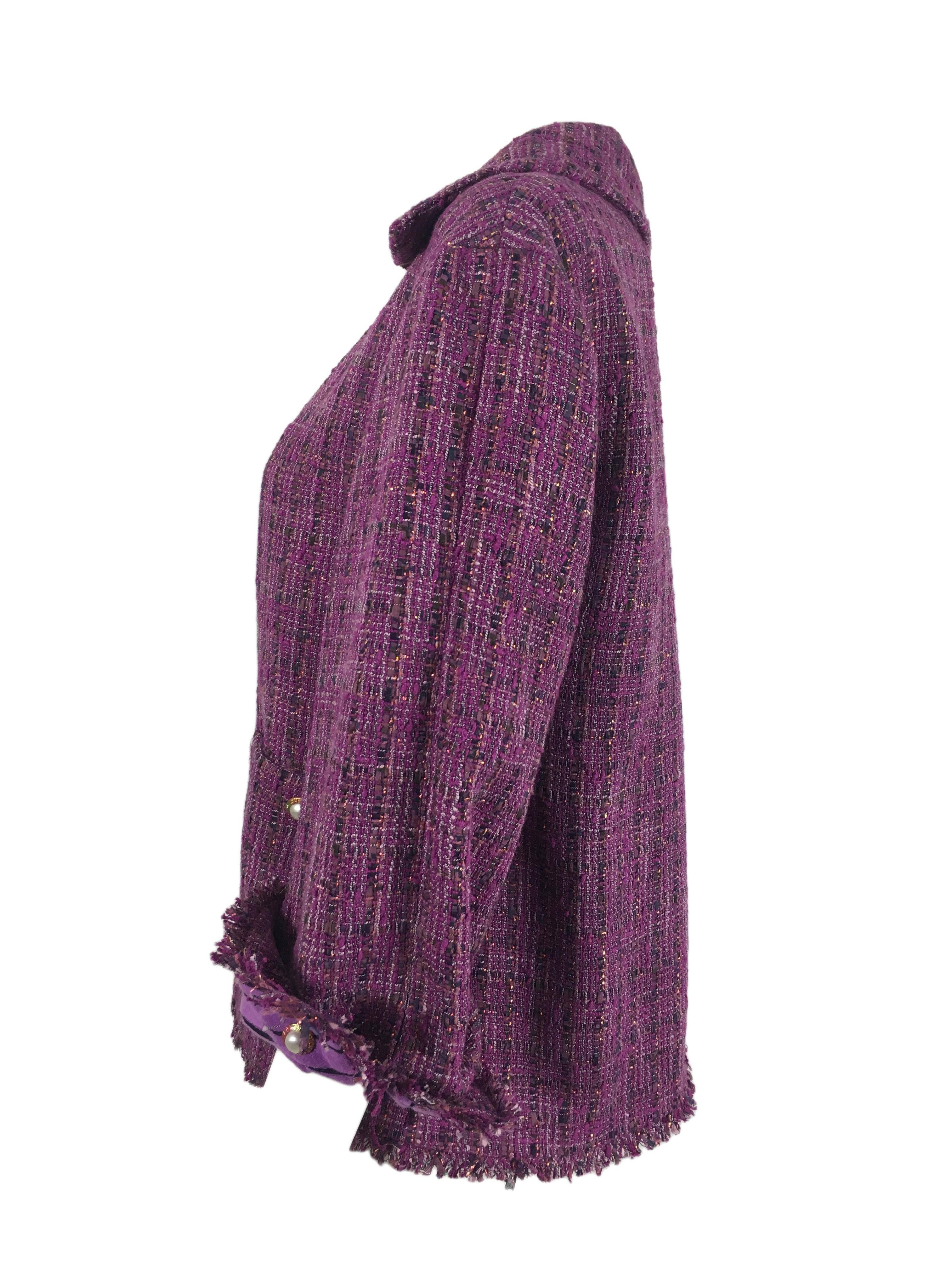 This tweed jacket features detachable zip front, two front pockets with fringed hem. Fringed rolled up cuffs with pearl buttons.  Fully lined in silk.