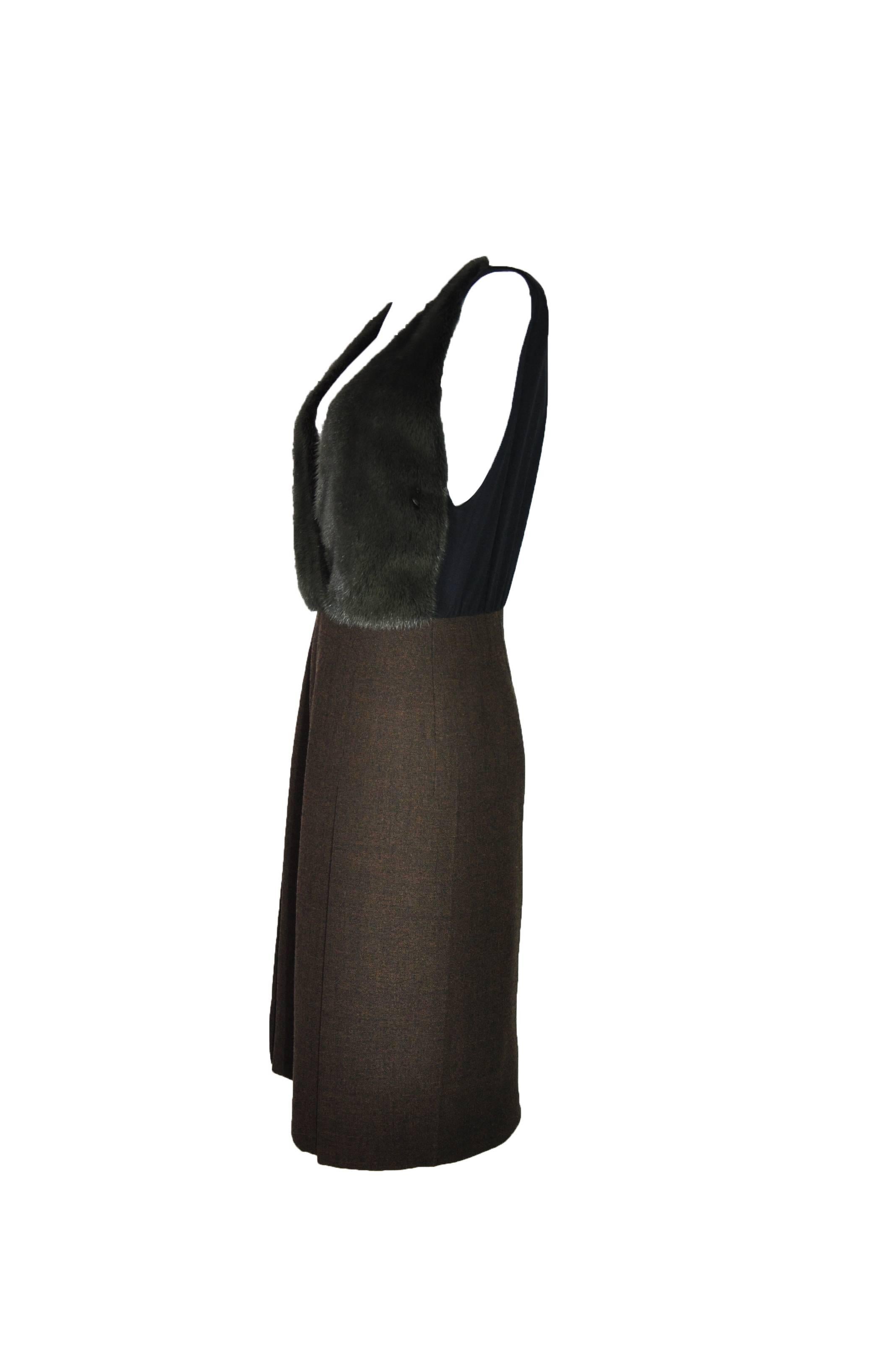 This sleeveless V-neck dress is beautifully crafted with a green dyed mink bodice match with a slightly flared front slit brown wool skirt.  Concealed zip fastening at back.