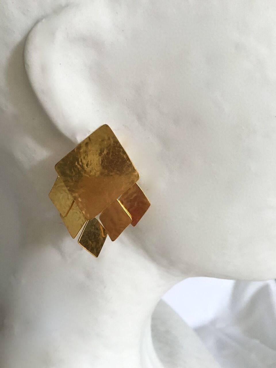 Hand hammered gold plated brass clip earrings from Herve van der Straeten. 