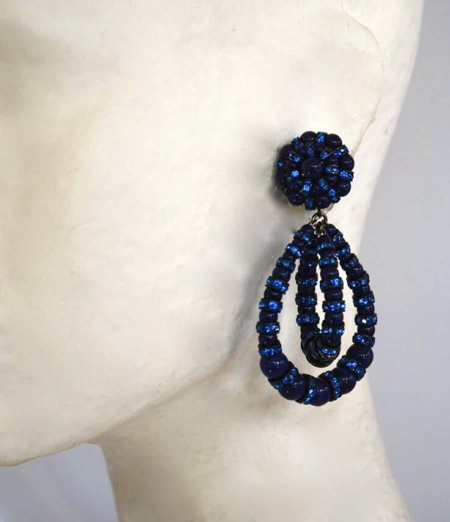 The iconic earring style from Francoise Montague in navy blue glass with vibrant blue crystal rondelles. These clip earrings dance as you move and are universally flattering. A must have addition to any collection.