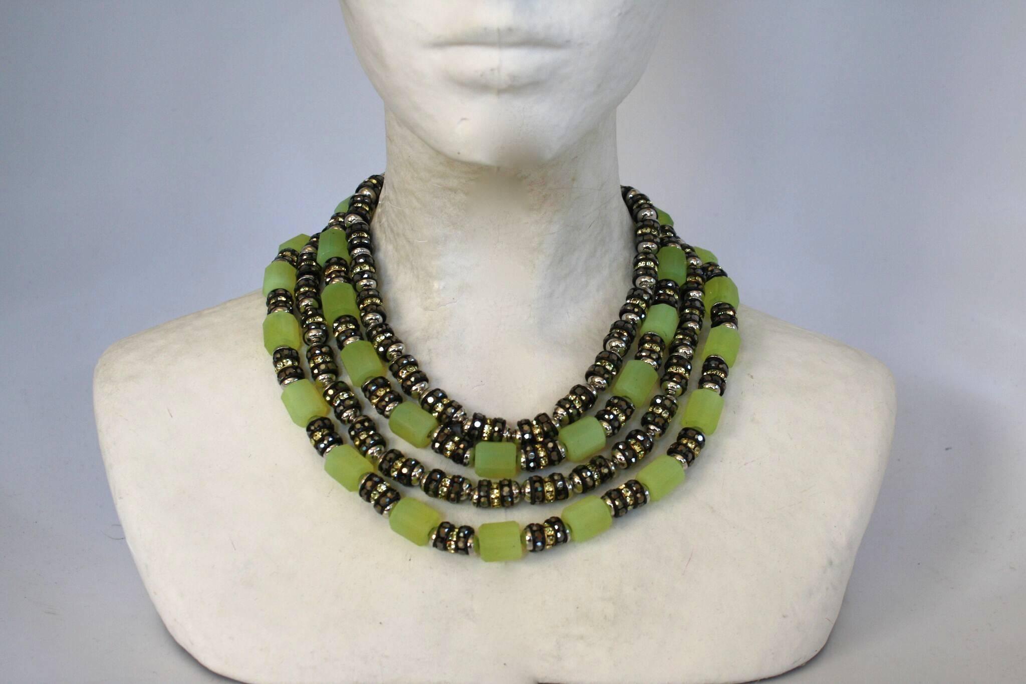 Four rows of gorgeous green vintage glass beads interspersed with Swarovski crystal rondelles from Parisian designer Francoise Montague.   

14