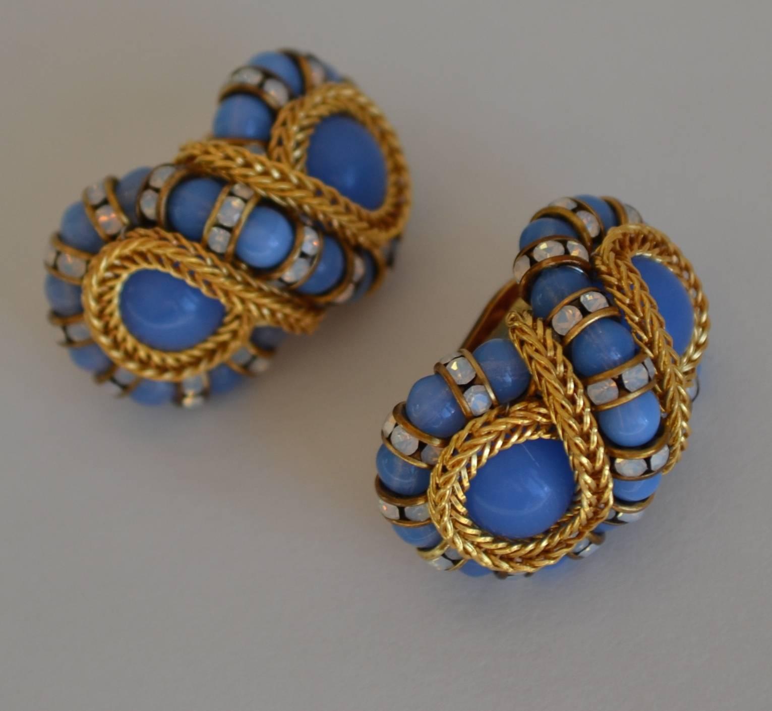 Blue clip earrings in a figure 8 shape with gold chain and Swarovski crystal rondelles from Francoise Montague.