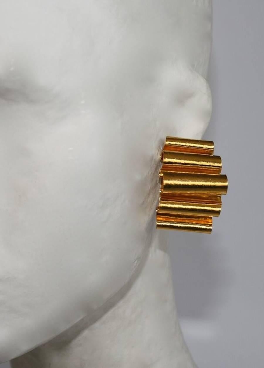 Multi-fold ribbon motif clip earrings in gold plated bronze from Herve van der Straeten. 