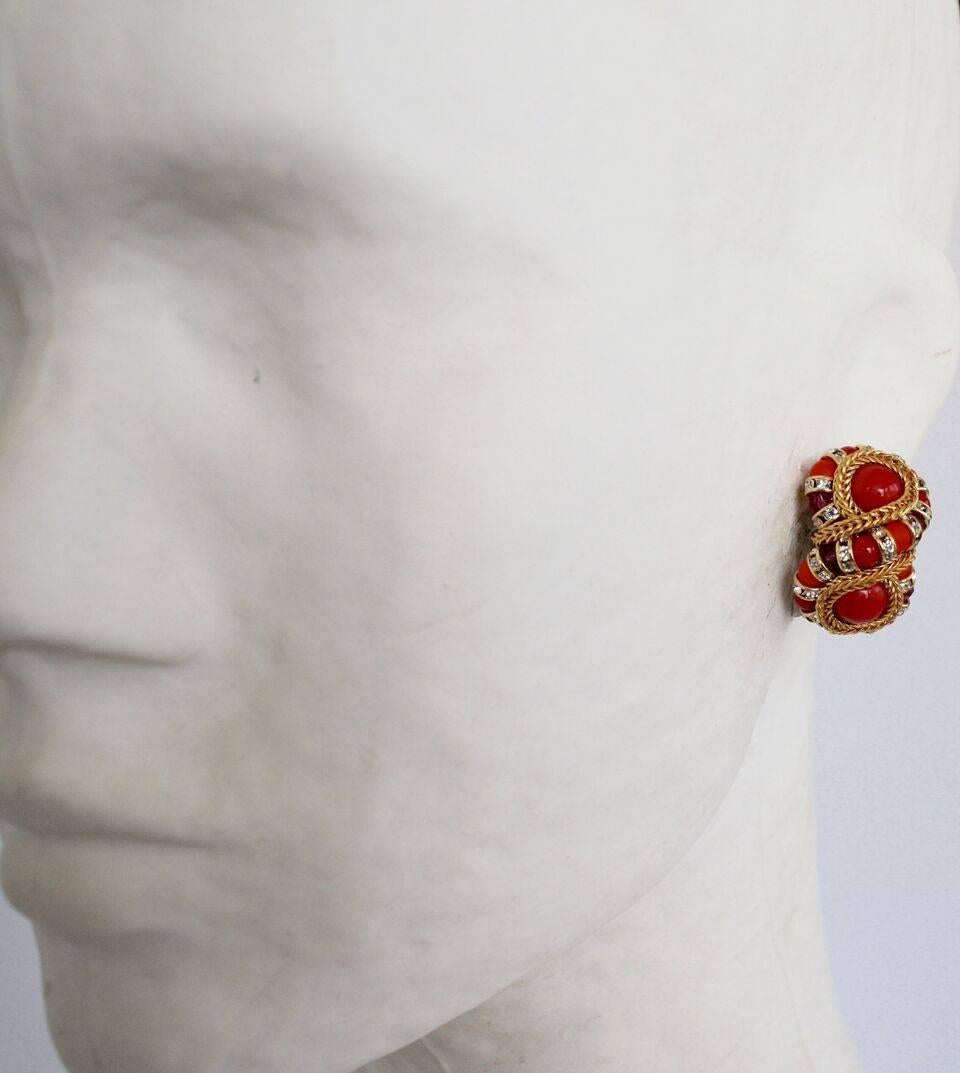Red clip earrings in a figure 8 shape with gold chain and Swarovski crystal rondelles from Francoise Montague.