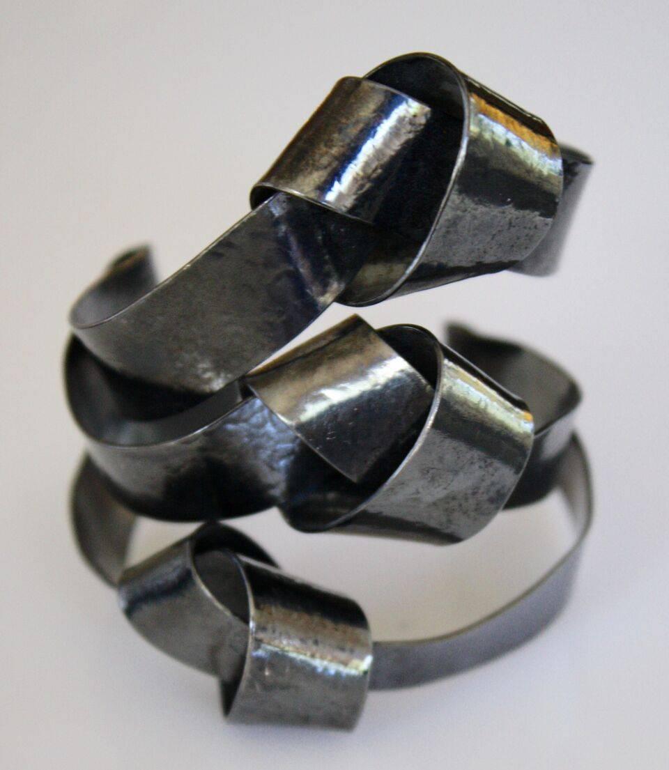 Rare cuff bracelet from Herve van der Straeten in dark metal with triple knot detailing. Bracelet is very light weight and opening is malleable, meaning it can fit both small and large wrists easily. 