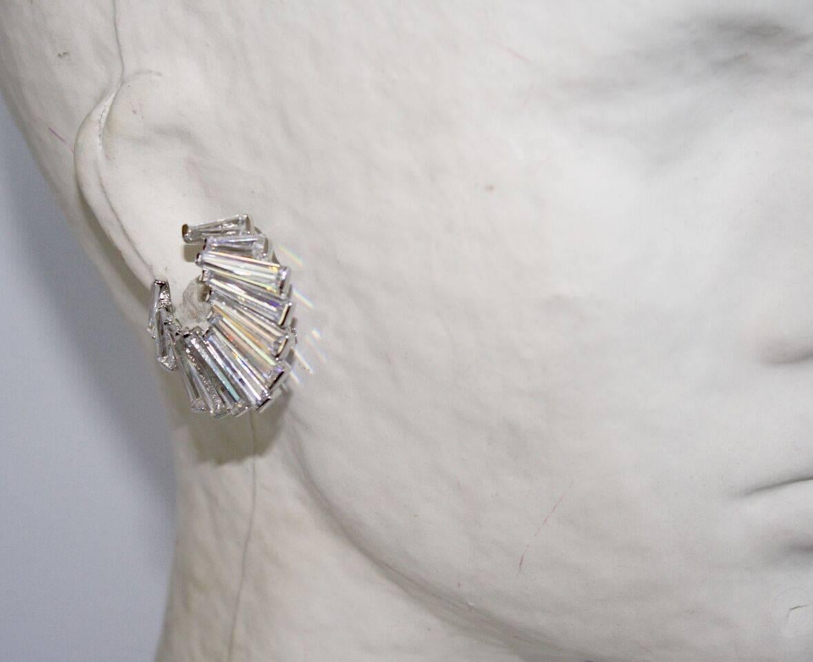 Graduated cubic zirconia baguettes come together to create a luxury look in these clip earrings. 