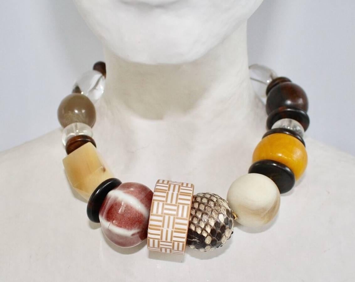 Limited Series rock crystal, wood, snakeskin, carnelian, and porcelain choker necklace from Philippe Ferrandis. 

