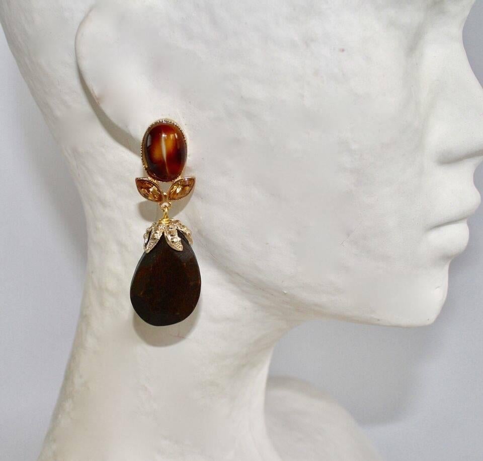 One of a kind pierced earrings from Philippe Ferrandis made with wood, glass cabochons, and crystals. 

2.25