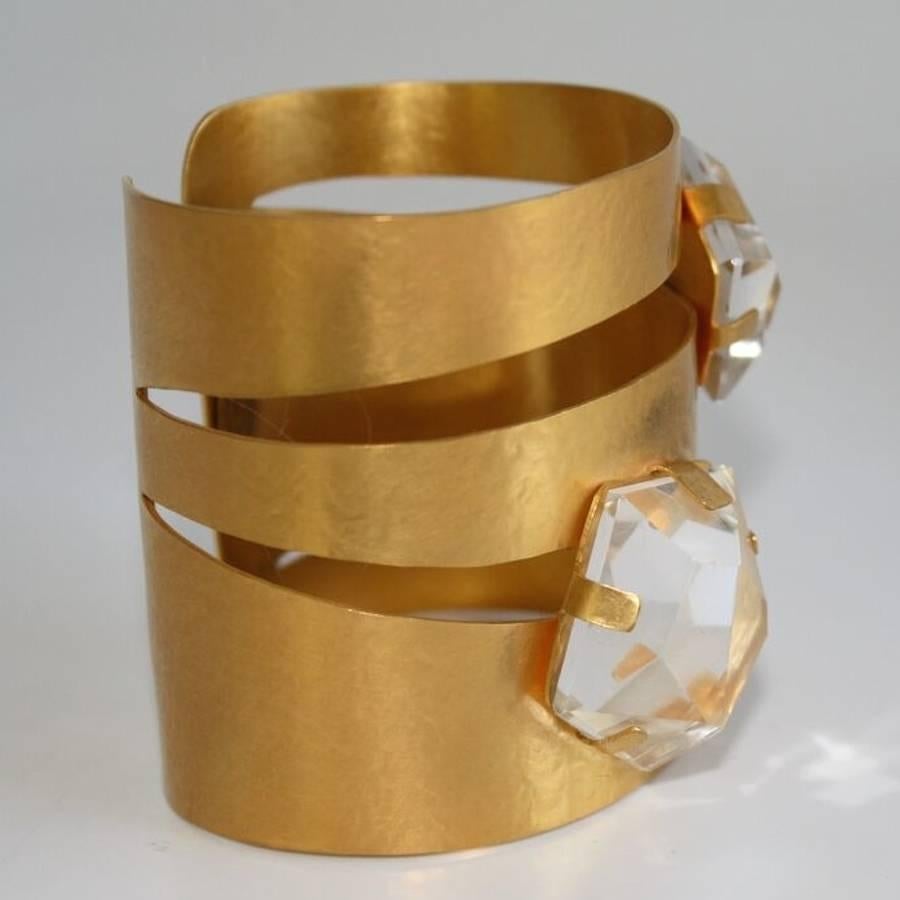 Hand hammered gold plated brass cuff bracelet with rock crystal detailing. Cuff is made with soft metal and is adjustable to all wrist sizes both small and large. 

2.5