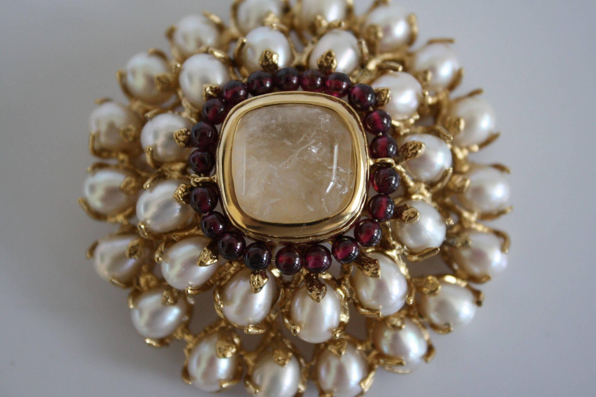 Baroque pearl, garnet, and rock crystal classic brooch from famed french design house Goossens Paris. 

2.25