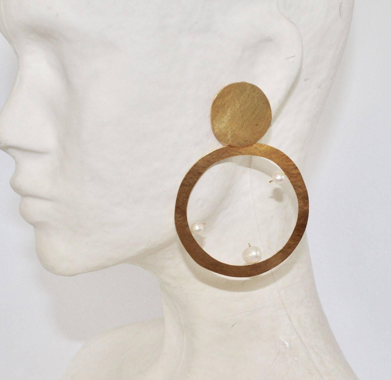 Gilded brass clip earrings with pearl detailing from Herve van der Straeten. 

3.5