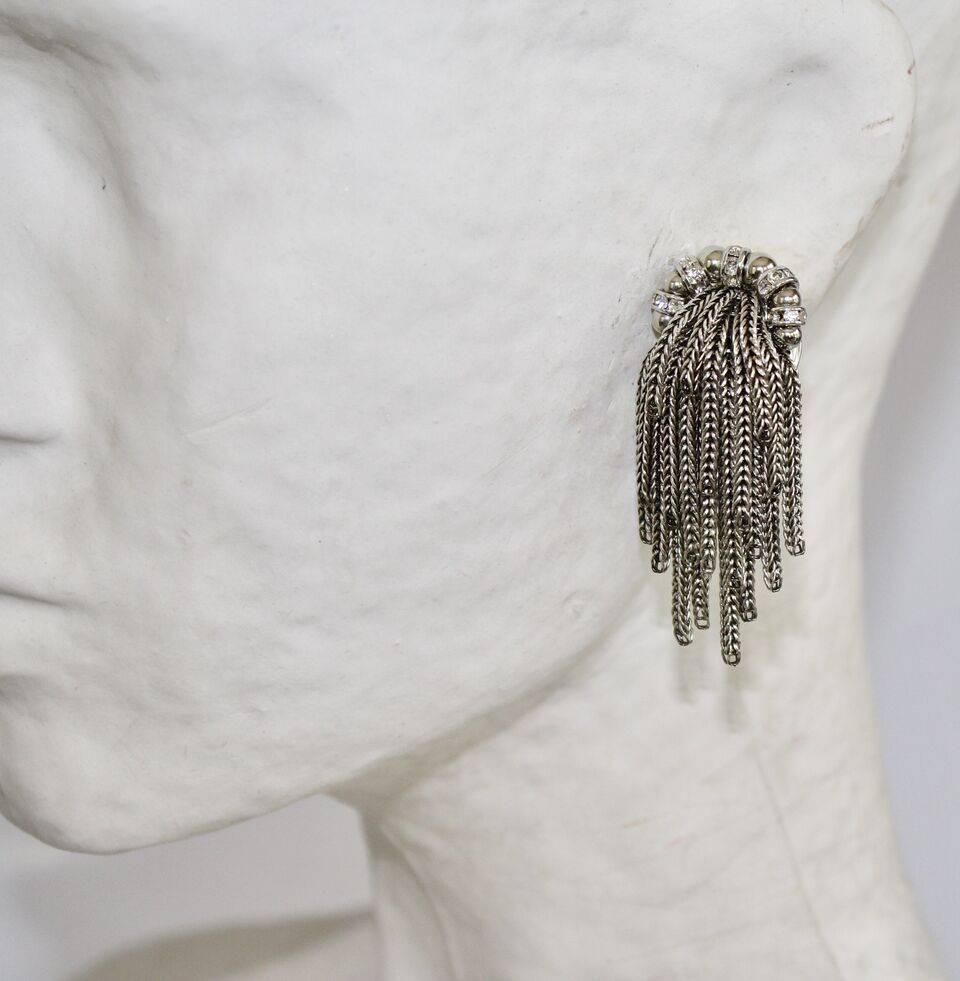 Rhodium tassel clip earrings with glass pearls and Swarovski crystals from French design house Francoise Montague. 