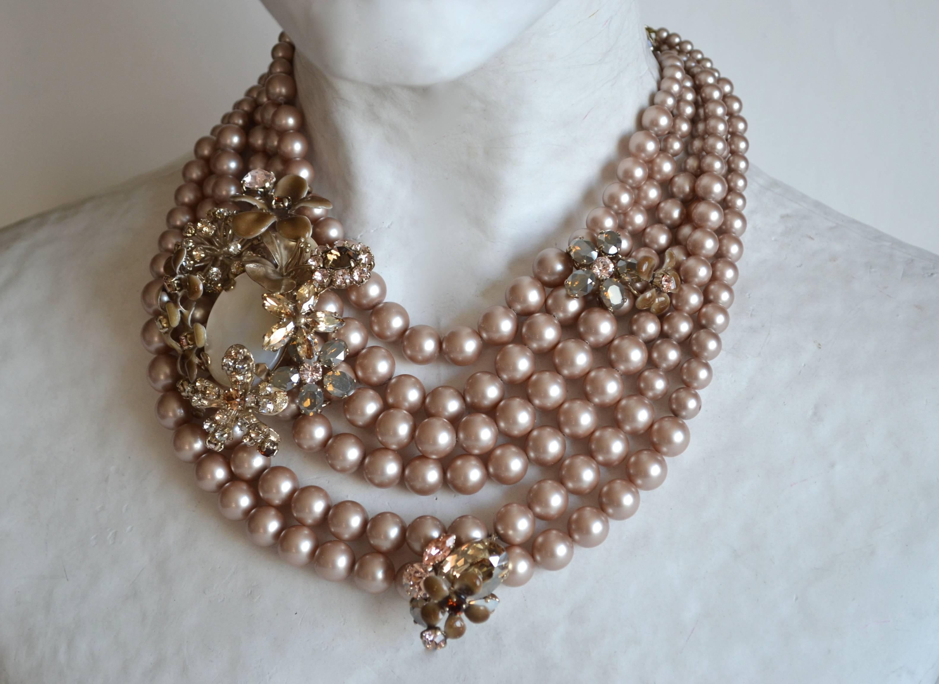 Six rows of gorgeous mauve glass pearls are adorned with fabulous floral crystal motifs in this extraordinary necklace from Philippe Ferrandis. 