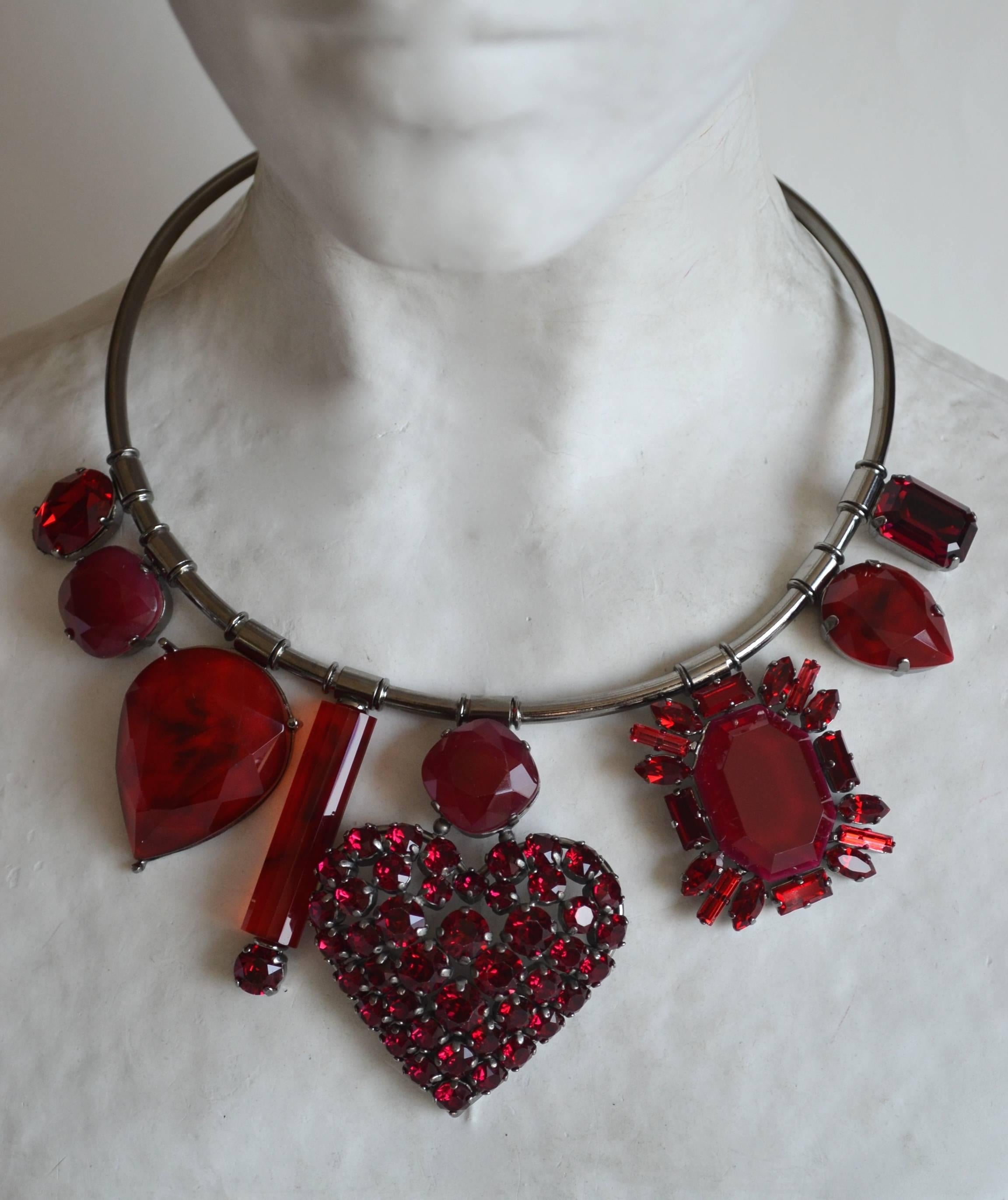 Red Swarovski Crystal stationary drops are set on a rhodium wire in this necklace from Philippe Ferrandis. 