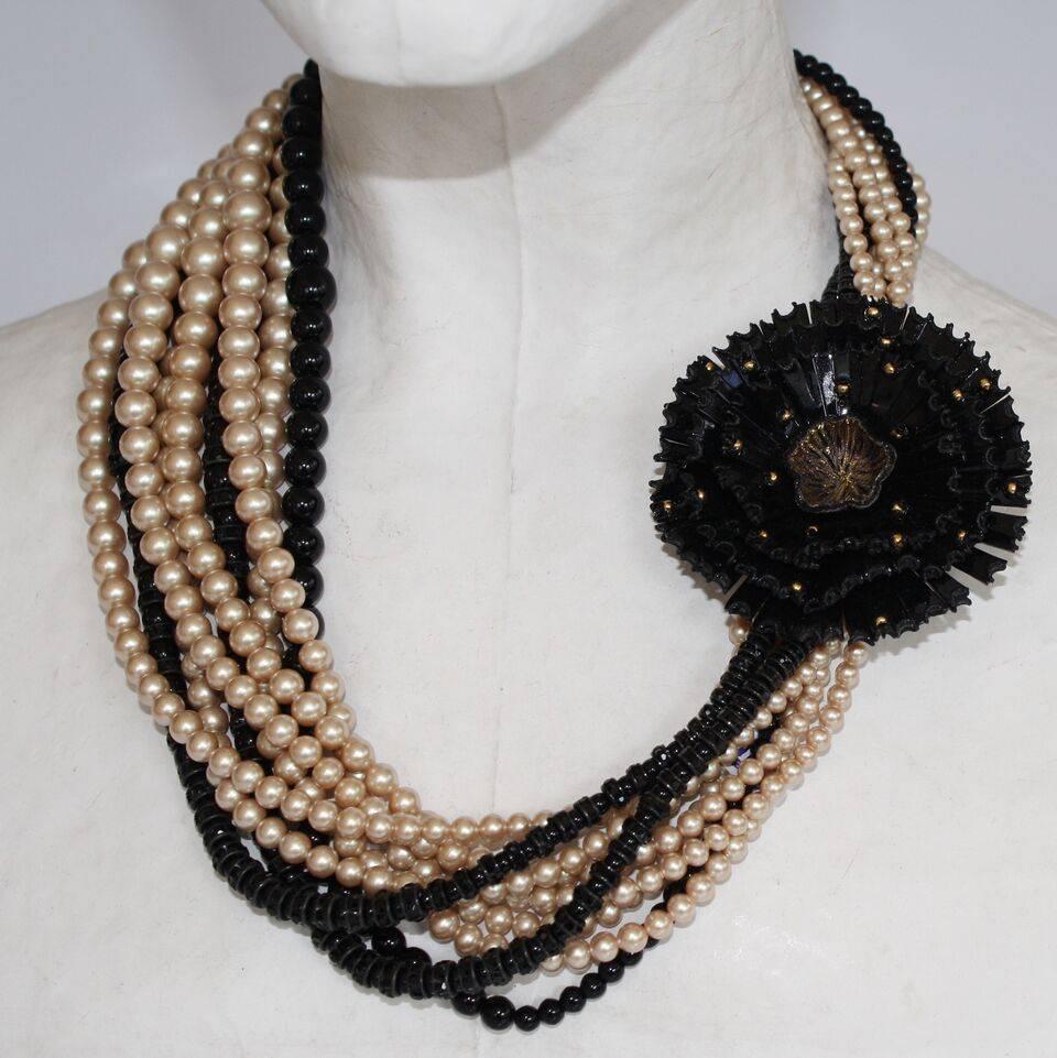 A twist of glass pearls come together with a fabulous resin closure in this wonderful necklace from French designer Francoise Montague.