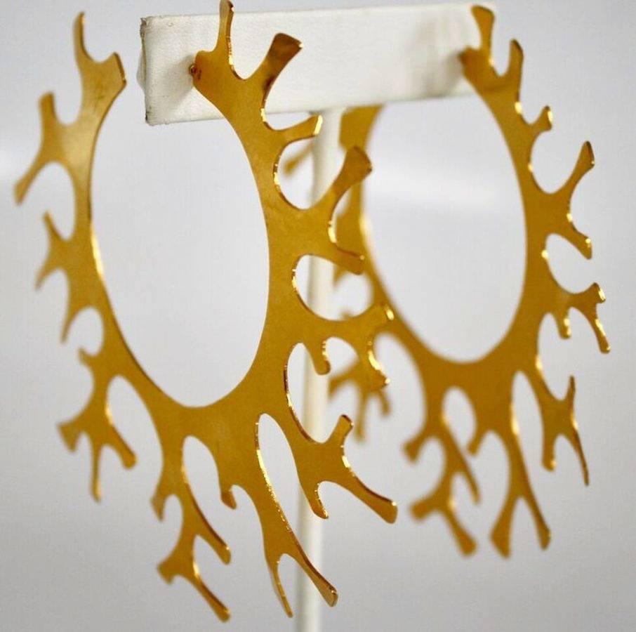 Inspired by coral, these oversized hoop earrings from Herve van der Straeten are made with gilded brass. They are incredibly lightweight!

3.25" diameter. 