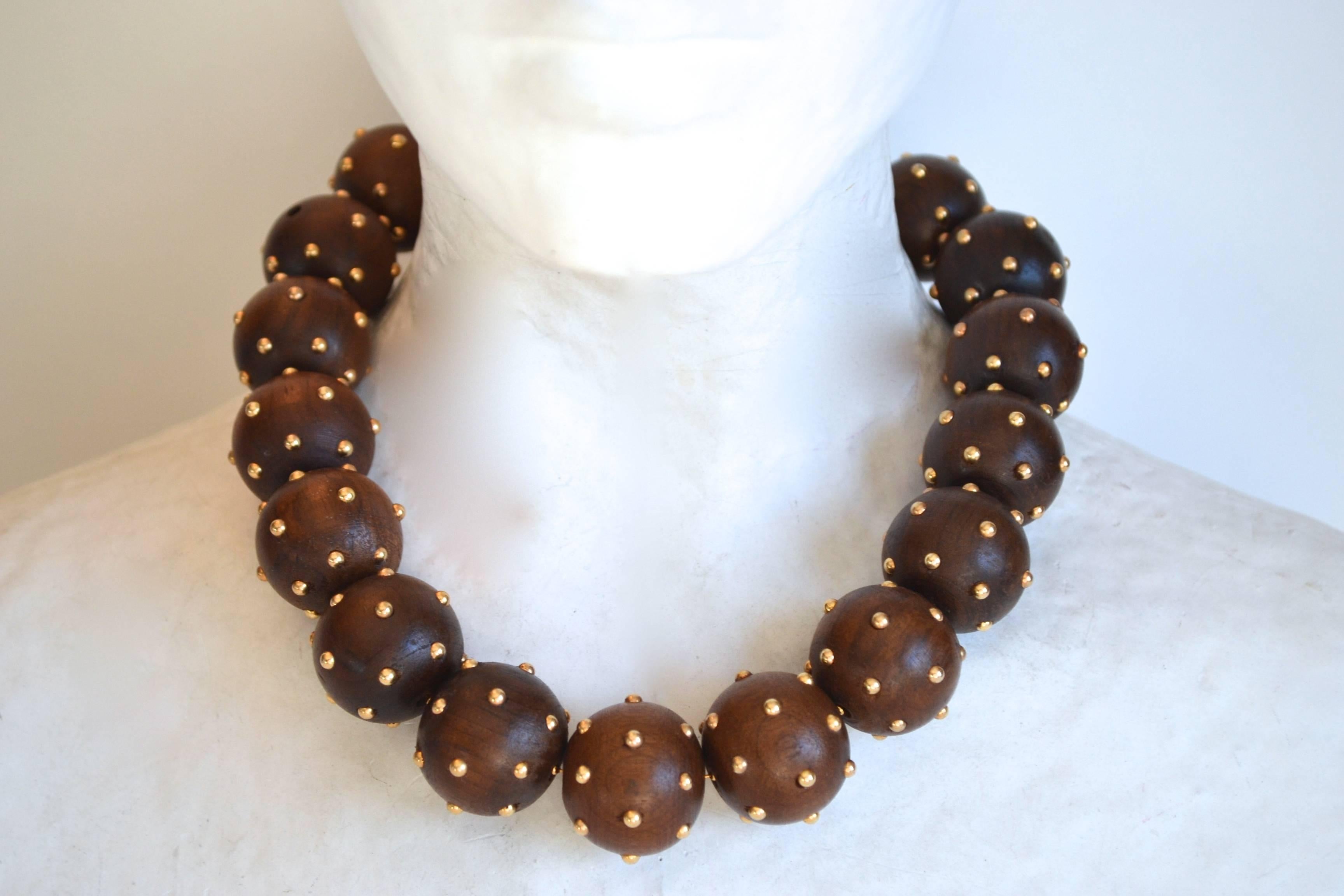 Brazilian walnut and brass bead multi-ball choker necklace from Brazilian designer Vanda Jacintho. 