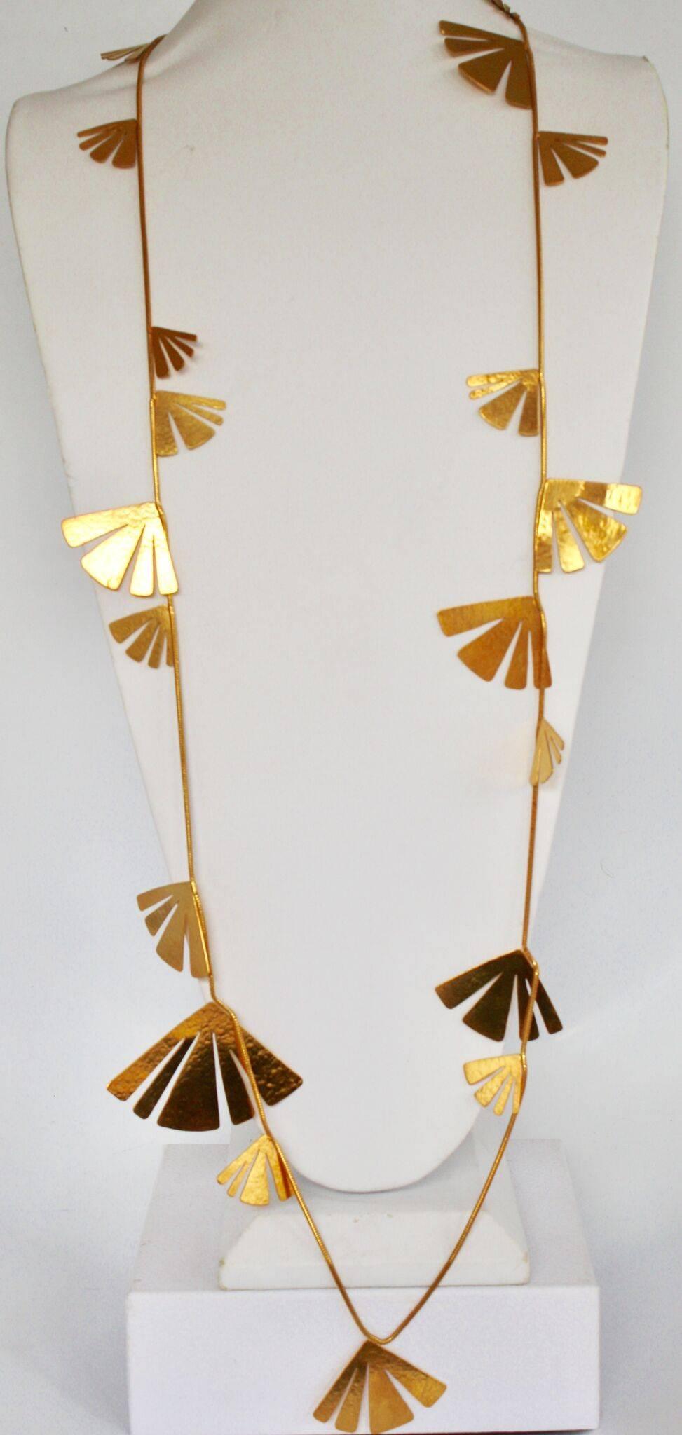 This designer is no longer producing jewelry, thus these pieces are now collectors items! Gilded brass sautoir necklace with fan motif from Herve van der Straeten. 

 Largest fan is 2.5”, smallest .5”