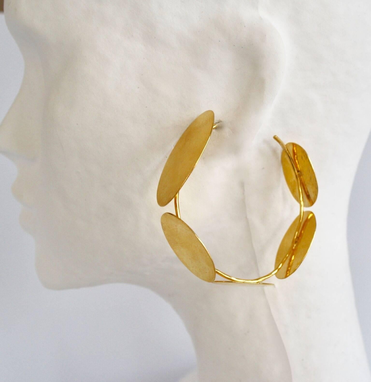 Gilded brass hoop earrings with multi petal motif from Herve van der Straeten. This designer is no longer producing jewelry, thus all pieces are now considered collectors items!