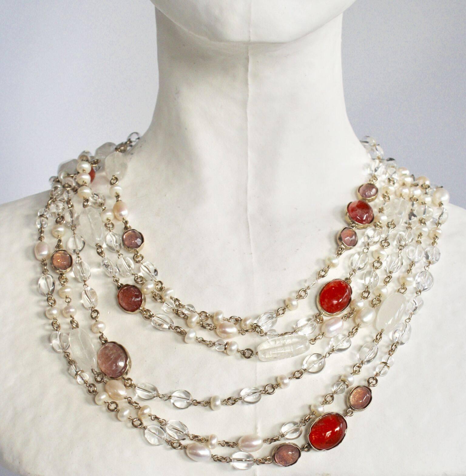 Triple row long necklace with hand painted rock crystals in pink/salmon surrounded by clear rock crystals and fresh water pearls. Necklace can be worn long or doubled and worn short to create a statement-making choker. From French design house