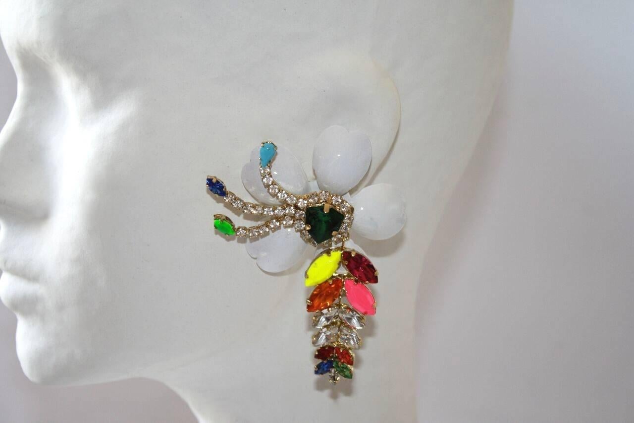 Big white enameled petals and multi-color Swarovski crystal pierced earrings from designer Shourouk. 