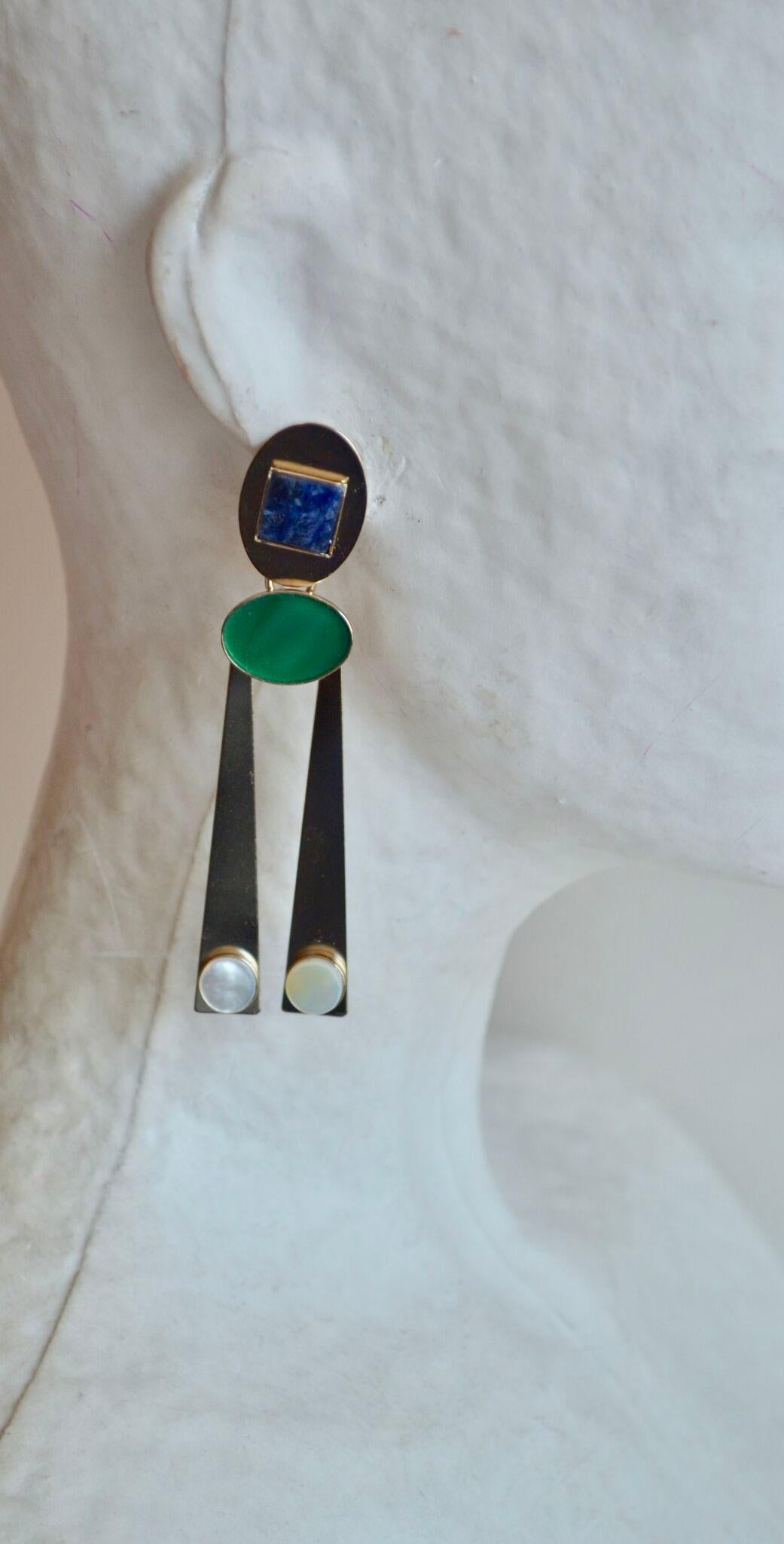 Palladium plated brass clip earrings with mother of pearl and jade cabochons from Philippe Ferrandis.