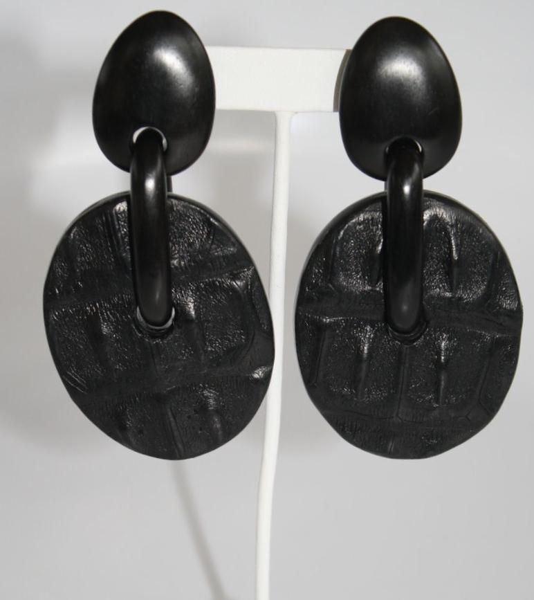 Croc motif embossed leather clip earrings on ebony wood from Monies Denmark. 