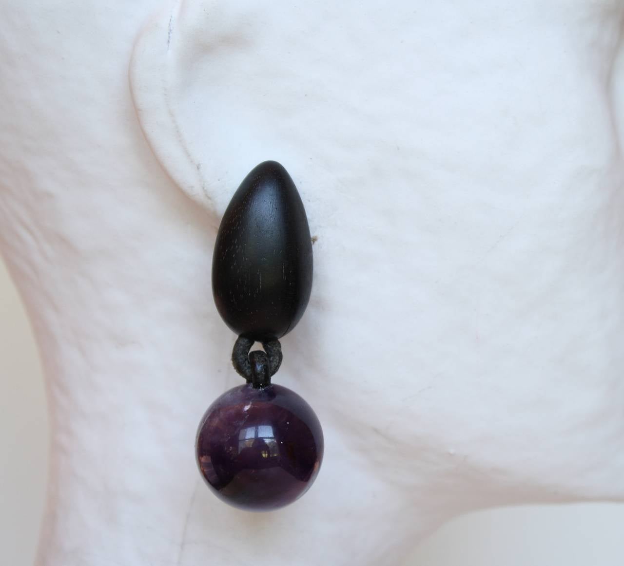 One-of-a-kind clip earrings from Monies, made with Ebony wood and purple amethyst.

2.5