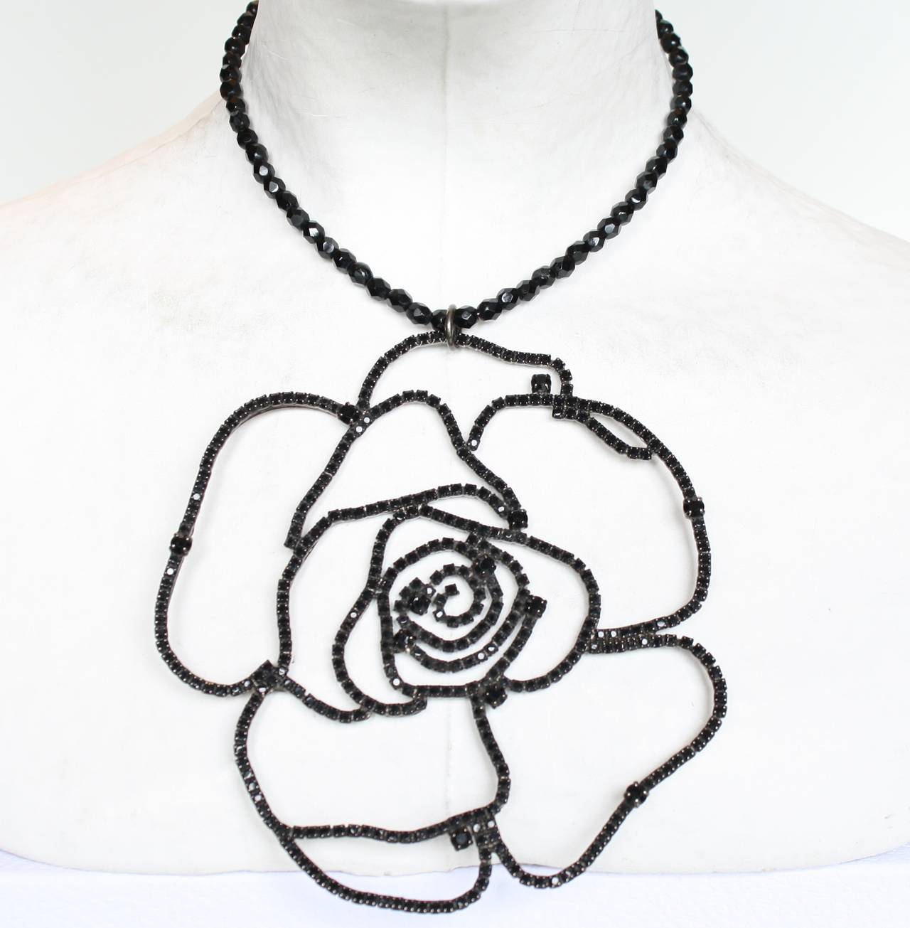 Delicate, yet packing a major punch, this camellia necklace from Francoise Montague is handmade with black Swarovski crystals and black glass beads. 

14