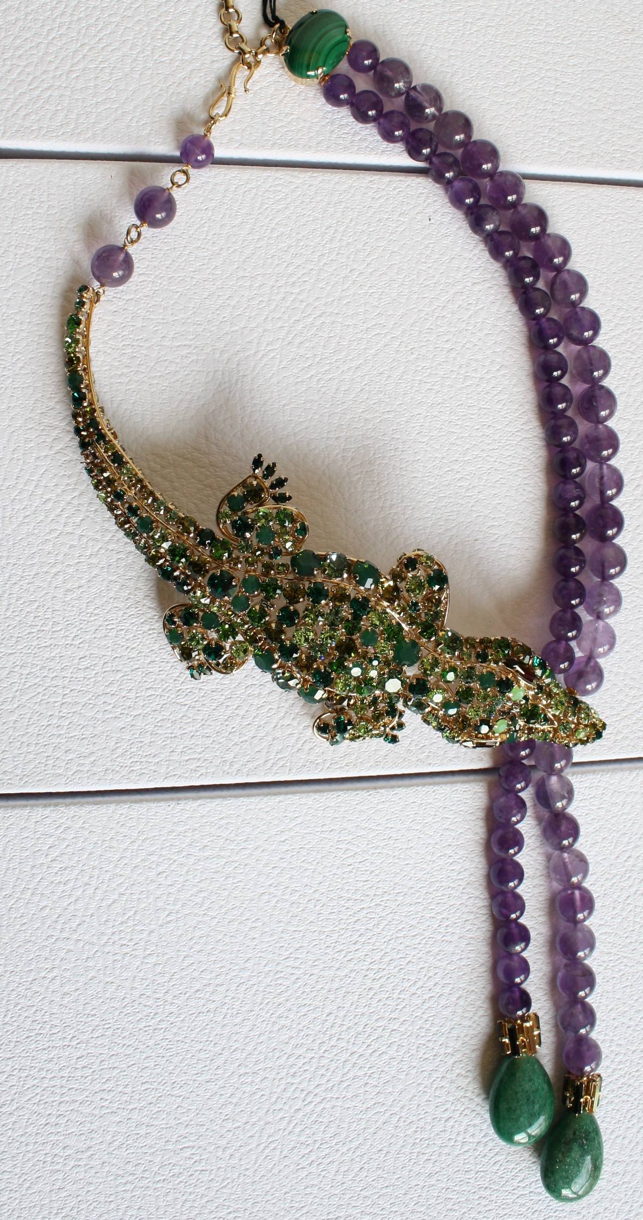 An extraordinary limited edition crocodile necklace from Philippe Ferrandis. Made with Swarovski crystals, amethyst beads, and serpentine.

18