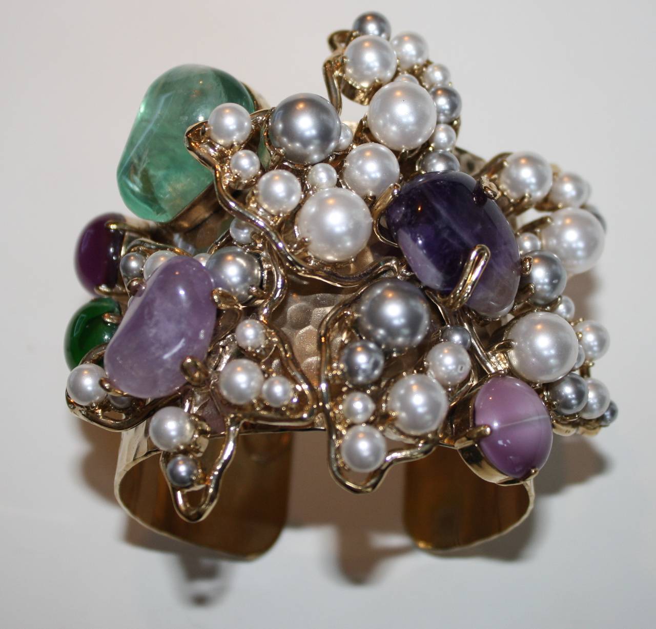 Pale gold coated cuff made with Swarovski beads, glass cabochons, fluorine, and amethyst from Philippe Ferrandis.

Designer Biography:

Philippe Ferrandis has been designing costume fashion jewelry and accessories since 1986. Based in Paris,