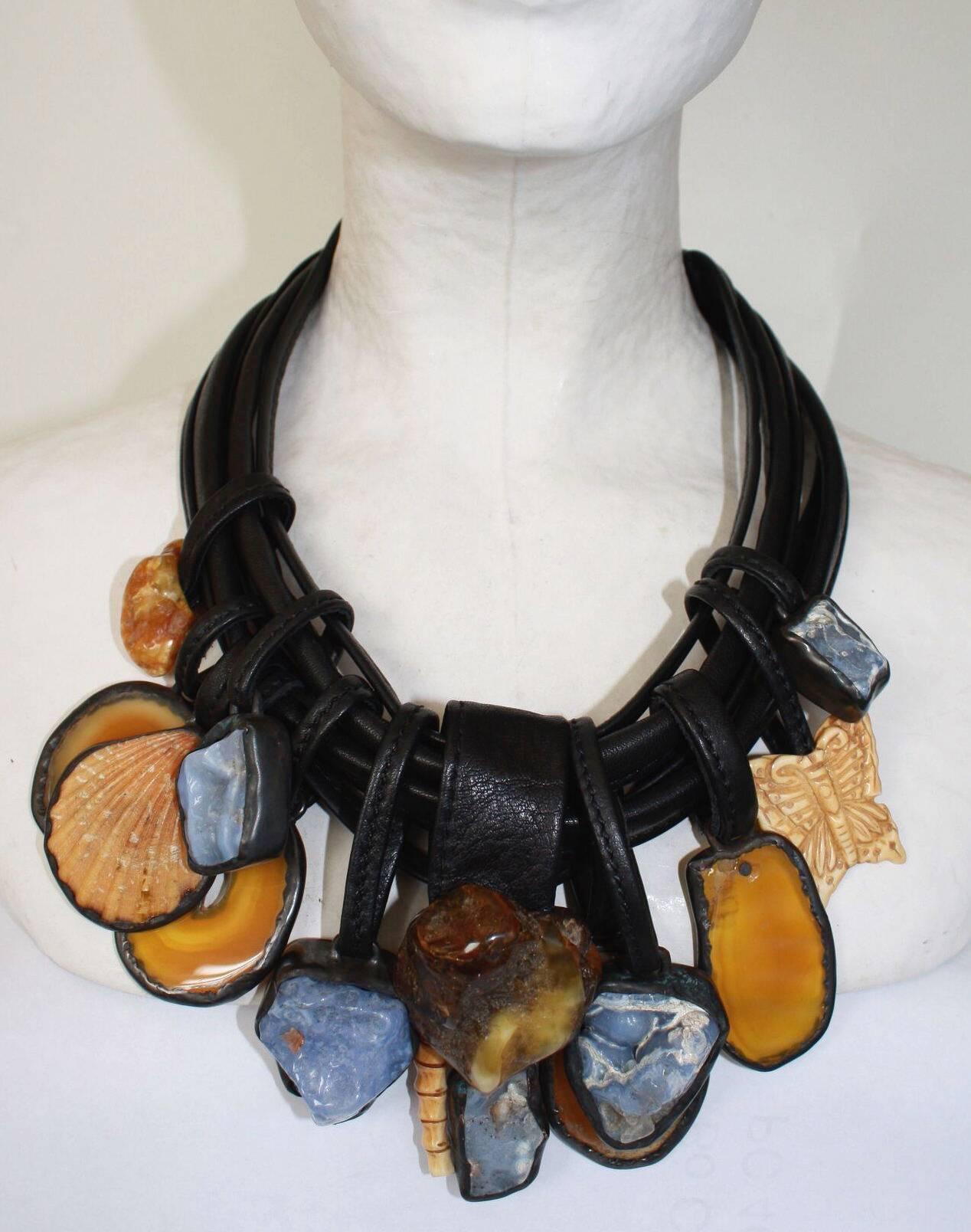One of a kind statement necklace made with multiple strands of leather, chalcedony, amber, agate, shell, bone, and ebony drops from Monies.

20