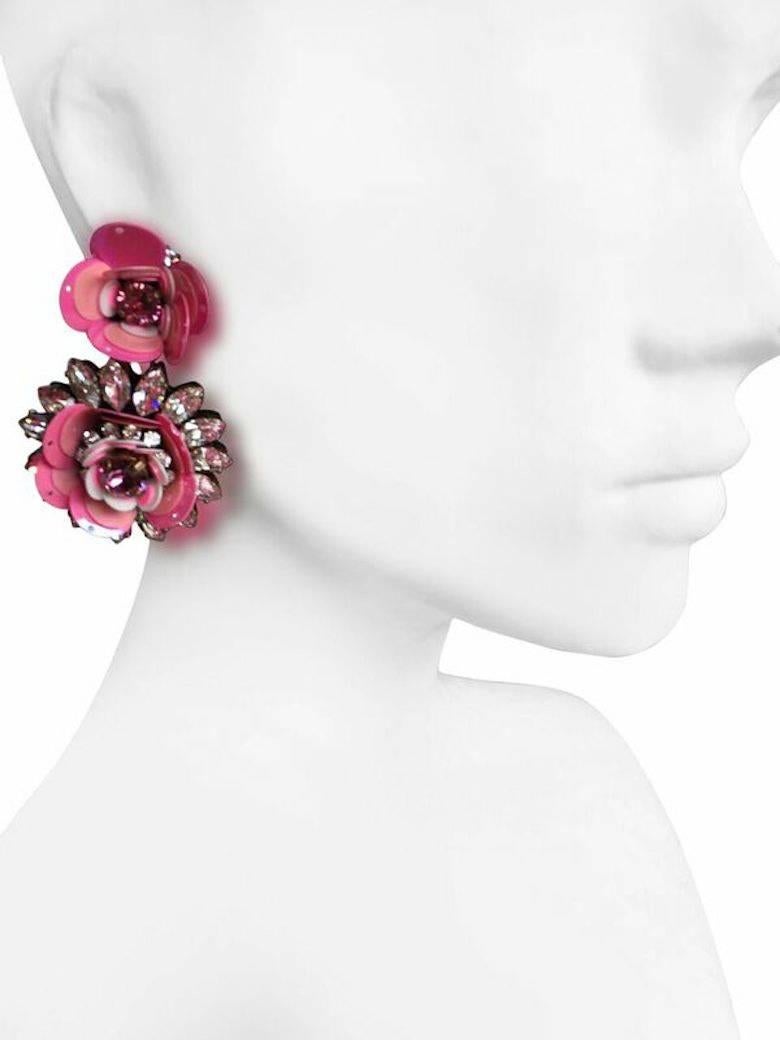 Pink flower clip-on earrings from Shourouk made with Swarovski crystals, metal sequins, and cotton backing.

Designer Biography:

Shourouk established her eponymous company in 2008. As a true Parisian, Shourouk graduated from the Studio Berçot